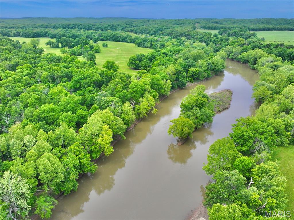 Along a private stretch of the Sac River, this 8.17 surveyed acre tract offers the perfect blend of seclusion, recreation, and build-ready convenience. With over 200 feet of direct river frontage and a secondary deeded river access point just upstream, you’ll enjoy multiple access locations to some of the best fishing, floating, and relaxing the Ozarks have to offer.
Located less than 2 miles off Highway 54 at the end of a dead-end county road, the property is accessed by a private road behind an electric gate providing both security and convenience. Electric is already run to the front of the property, making future development simple whether you’re planning a weekend cabin, hunting retreat, or full-time residence.
The land features a beautiful mix of open ground and mature timber with a prime open build area near the road while still maintaining excellent privacy. Large hardwoods create a tall shaded canopy throughout the property, while creeks bordering both sides add to the natural beauty and provide excellent wildlife travel corridors. Deer and turkey sign are abundant, making this an outstanding recreational tract for hunting and outdoor enjoyment.
The combination of river frontage, secondary deeded access, utilities, privacy, and build potential is hard to find in today’s market. Additional adjoining acreage is also available for purchase if you’re looking to expand. Whether you’re searching for a peaceful getaway or a future riverfront homesite, this secluded Sac River property checks all the boxes.