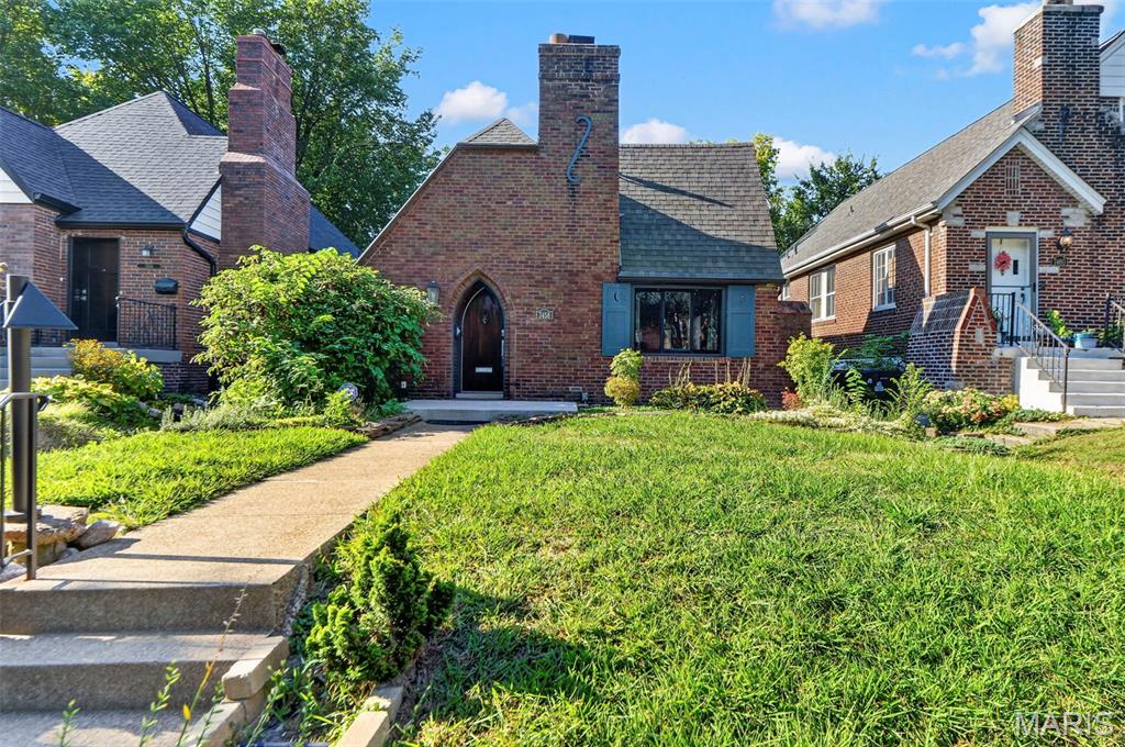 Historic charm meets custom modern luxury at 7458 Gannon Avenue! Nestled along a beautiful tree-lined street in University City, this classic 1929 English Tudor blends timeless architectural character with thoughtfully designed updates and approximately 3,048 sq. ft. of finished living space across two levels.

Step inside to a light-filled main level offering 1,728 sq. ft. of above-grade living space, where arched entryways, crown molding, and classic architectural details preserve the character of the home. The spacious living room is centered around a beautifully re-sculpted historic fireplace hearth, creating a warm focal point for everyday living and entertaining.

At the heart of the home is a showstopping custom Danish wood kitchen featuring sleek architectural cabinetry and premium integrated Sub-Zero and Bosch appliances. Designed with both style and function in mind, the kitchen brings a distinctly modern feel to this historic home.

The main level offers two spacious, sun-filled bedrooms and beautifully updated bath spaces, providing a comfortable and functional layout for daily living.

Downstairs, the expansive finished lower level adds approximately 1,320 sq. ft. of additional living space and incredible versatility. The lower level includes a permitted third bedroom, generous recreation and family room areas, dedicated storage, and plenty of room to create a guest retreat, home office, media room, fitness space, or a combination of uses.

Thoughtful conveniences continue throughout the home, including a built-in central vacuum system servicing multiple levels.

Outside, the backyard becomes an extension of the living space with a custom natural stone outdoor kitchen, creating the perfect setting for summer dinners, weekend grilling, entertaining, or simply enjoying evenings at home.

All of this is tucked into an incredible University City location just minutes from Clayton, Washington University, BJC, Forest Park, the Delmar Loop, local parks, restaurants, shopping, and more.

From its original 1929 Tudor architecture and restored details to its custom kitchen, expansive finished lower level, modern conveniences, and outdoor entertaining space, 7458 Gannon Avenue offers a rare combination of historic character, thoughtful design, and flexible living space in the heart of University City.