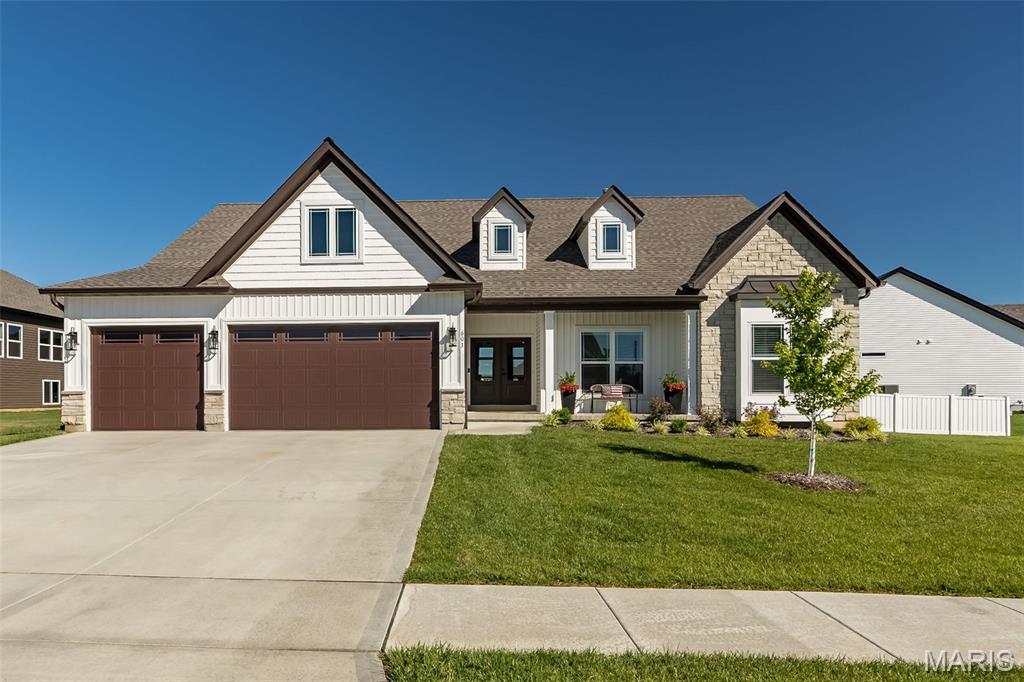 Why wait to build when you can have the upgrades and extras now? Located in one of Moscow Mills newest subdivisions, Orchard Grove, this barely one-year-old modified Kensington model offers everything the display home has - and more! From the striking double front doors to the thoughtful custom modifications throughout, this home was designed to impress. Upgrades include a 2-foot rear bump-out for added living space, an oversized garage with 4 extra feet of depth, 8’ garage doors, and an extra-wide 9’ single garage door, plus a 6’ x 18’ extension connecting the garage to the spacious 18’ x 16’ covered patio. Inside, you’ll love the soaring 10’ ceilings throughout the main living areas and 9’ ceilings in the bedrooms and baths. The dream kitchen is loaded with upgrades including stunning Cambria quartz countertops, staggered-height cabinetry, GE Profile stainless appliances, double wall ovens, drawer microwave, farmhouse sink, and an oversized butterfly island with seating for six. The impressive walk-in pantry is a standout feature with convenient countertop-height outlets for added functionality. The oversized covered patio is the perfect extension of your living space, featuring a ceiling fan and overlooking the fully fenced yard with irrigation system. The spacious primary suite offers a luxurious retreat with an oversized bedroom, double bowl vanity, a huge walk-in shower with dual shower heads, and a generous walk-in closet. Two additional bedrooms and a full bath complete the main floor. The unfinished lower level offers endless possibilities with an egress window and full bath rough-in, ready for your personal touch. This one checks all the boxes and then some!