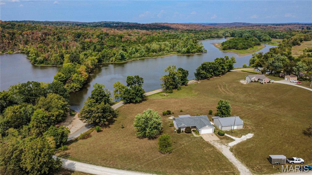 Stunning Lakeview Home on 3+ Acres with Income Potential

Welcome to your dream retreat overlooking beautiful Fredericktown Lake! This meticulously updated property sits on over 3 acres, offering privacy, space, and breathtaking views. The main home features a spacious 2-car attached garage, plus a detached garage with an incredible bonus: a fully finished one-bedroom mother-in-law suite/apartment—perfect for guests, extended family, or generating income as an Airbnb.

Inside the main house, enjoy brand-new hardwood and tile floors throughout the main living areas, complemented by fresh paint and modern fixtures. The fully finished walk-out basement boasts a second kitchen and brand-new flooring, making it ideal for entertaining or multi-generational living.

The main kitchen has been beautifully upgraded with brand-new quartz countertops and appliances. Step outside to two new covered decks—one on the main house and another on the suite—where you can relax and take in the panoramic lake views.

Additional Highlights:

- Brand-new walk-in tile shower in the apartment

- All new HVAC system in the apartment

- New flooring and finishes throughout all living spaces

- Multiple living areas for flexible use

- Peaceful setting with expansive outdoor space

This unique property blends comfort, functionality, and potential income in a truly beautiful location. Don’t miss your chance to own this exceptional home!