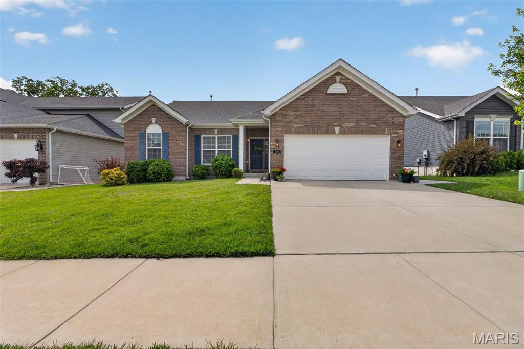Welcome to this darling, thoughtfully maintained and updated ranch home in the heart of Jefferson County! Step through the front door into a bright, inviting open floor plan with vaulted ceilings, abundant natural light, and newer engineered hardwood flooring throughout the main level. The spacious living room is cozy and functional, centered on a charming wood-burning fireplace. The kitchen and dining area flow together, with direct access to the expansive 15' x 15' composite deck overlooking a large backyard that backs to peaceful, wooded common ground—ideal for relaxing evenings or outdoor entertaining. Families will appreciate the included backyard playset, ready for the next owners to enjoy. Convenient main-floor living includes a laundry room, a spacious primary suite with an updated en-suite bathroom, three additional bedrooms, a full hall bath, and an oversized two-car garage. The newly finished walk-out lower level (2025) significantly expands the living space and offers endless possibilities. Featuring recessed lighting, an electric fireplace, LVP flooring, and large sliding glass doors that fill the space with natural light, this level is ideal for a family room, recreation area, or media space. The lower level also features an additional bedroom and full bathroom, offering excellent flexibility for guests, a home office or fitness space. There is still plenty of unfinished storage space, and the covered patio provides another wonderful outdoor living area. Newly installed exterior stairs offer convenient access from the front of the home directly to the backyard, making entertaining a breeze. With thoughtful updates, flexible living spaces, and a serene setting, this move-in-ready home offers the perfect combination of comfort, functionality, and charm. Schedule your showing today!
