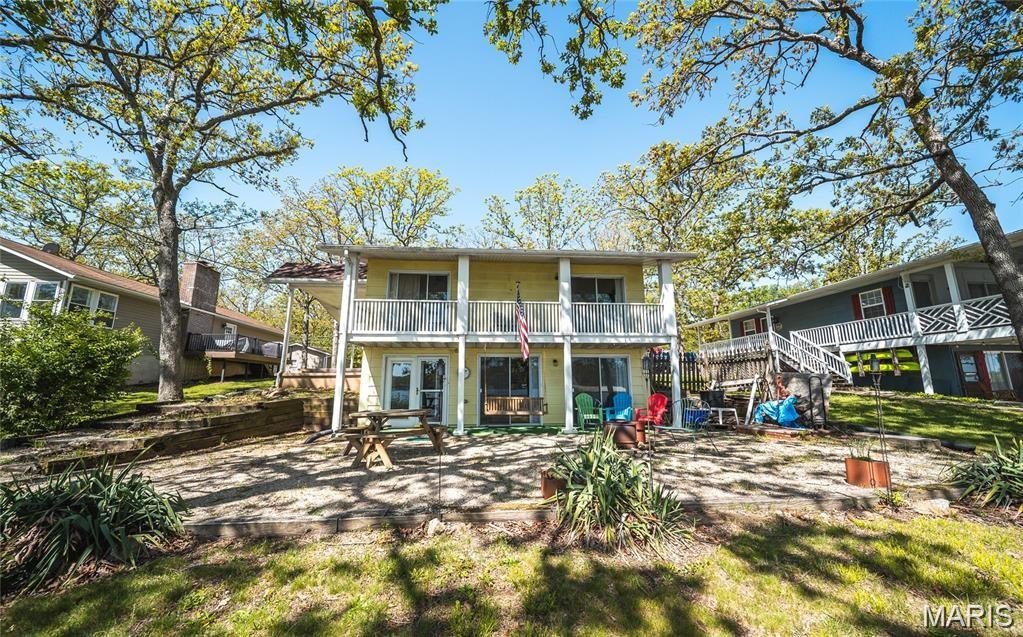 Furnished Lakefront home!! This home is turnkey and ready for you, impecibly maintained, you have 2 bedrooms with connected balcony for amazing coffee morning and sunrise/set views. Can easily sleep 10 set up the way it is.  The kitchen and living room are downstairs and walk out to your large patio, porch swing, fire pit, beautiful yard and your own permanent dock. You have large garage for lake toys and shed for lawn storage. This home is on a dead end road, so low traffic. Indian Lake is an hour from St Louis, a gated community buildt around a 326 acre lake. You can boat, fish, tube, ski, jet ski, and more. The community offers social activities and clubs, has a marina, general store, tennis courts, pickleball, basketball, playground and beach.... what else do you need??? for more info on Indian lake go to https://ilpoa.org