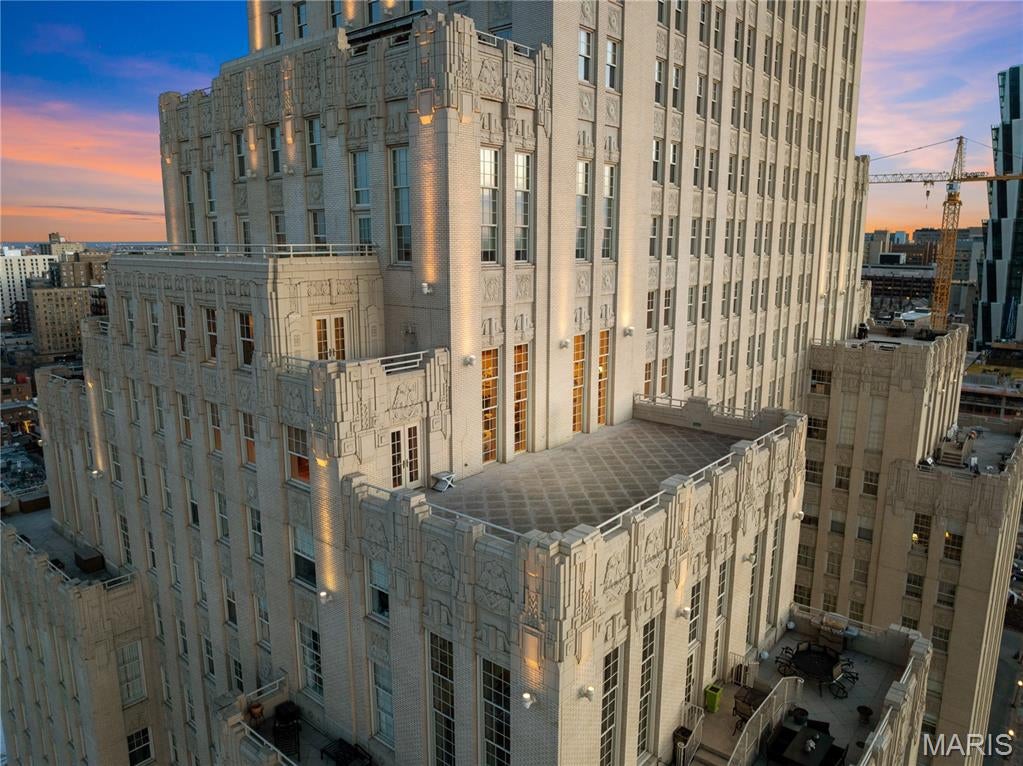 In real estate, location is often revered as the ultimate driver of value, but there is one factor even more powerful: the inability to replicate. This extraordinary residence offers both. Perched high above the city, this rare two-level condo is anchored by an expansive ~1,000 sq ft private terrace with jaw-dropping, unobstructed views spanning Forest Park and the St. Louis skyline. From sunrise to sunset, the perspective is cinematic and ever-changing, offering a constant visual connection to the best of St. Louis, an experience that simply cannot be recreated. Words can only begin to describe the scale, depth, and emotional impact of these views. Inside, the home is a masterclass in thoughtful design. Custom wood features are treated as art, highlighted by a striking floor-to-ceiling peek-through fireplace framed in rich architectural woodwork. The main level offers a large eat-in kitchen, spacious living room with soaring views, formal dining room, bedroom suite, generous laundry room, half bath, and an incredible library/office wrapped in floor-to-ceiling built-ins, ideal for work-from-home living without compromise. A dramatic open staircase, worthy of Architectural Digest, leads to the second level featuring a flexible loft space ideal for a theater, lounge, or secondary office, and a breathtaking primary suite with dual bathrooms, dressing area, and abundant closet space. A second private terrace off the primary suite offers what may be the best morning coffee space in all of St. Louis. Residents of The Chase Park Plaza Residences enjoy a truly unmatched lifestyle with 24-hour doorman and concierge services, valet parking, fitness center, swimming pool, private movie theater, multiple on-site dining options, and direct access to the iconic Chase Park Plaza, combining luxury, convenience, and prestige in one of the city’s most irreplaceable locations.