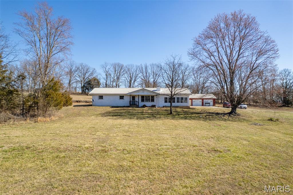 Location, Location!

This beautifully updated three-bedroom, two-bathroom home is conveniently located just 13 minutes from town and situated on five peaceful acres, offering both privacy and the opportunity to accommodate horses or cattle.

The spacious backyard provides the perfect setting for children to explore and enjoy the outdoors. Inside, the thoughtfully updated kitchen features a large island ideal for meal preparation and entertaining. The adjoining dining room offers lovely views of the backyard, creating a bright and welcoming space for gatherings.

The updated family room boasts abundant natural light from numerous windows and offers ample space for entertaining or a dedicated play area. The inviting living room features a cozy wood-burning fireplace, with an insert for the extra heating source on those extremely cold days or just relaxing evenings at home.

The primary suite is generously sized and includes a private en-suite bathroom. A large laundry room, complete with utility space, adds convenience and functionality. This home also includes a security system and a whole-house water filtration system for added peace of mind.

Hardwood floors run throughout the home, complemented by expansive windows that showcase the surrounding scenic views. The carport accommodates two vehicles with additional space for outdoor cooking equipment and grills. A separate two-car garage provides excellent storage for lawn equipment, tools, and more.

With ample room for four-wheelers, animals, and outdoor enjoyment, this property offers the perfect blend of comfort, space, and country living.