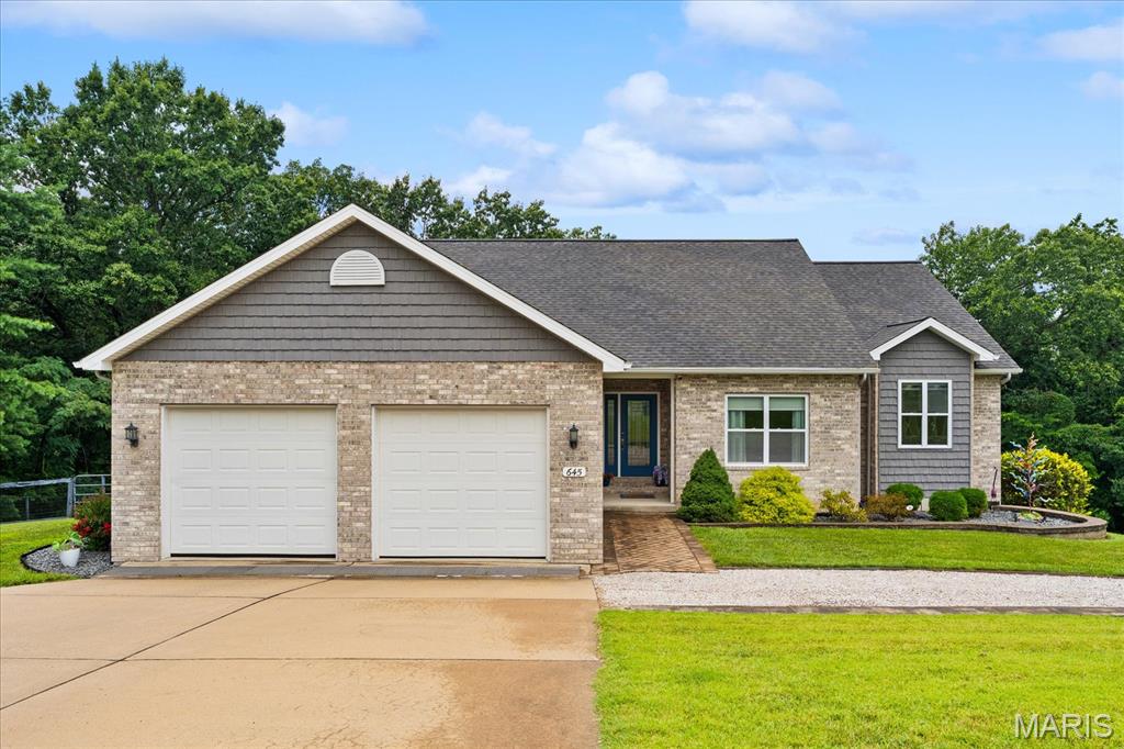 Tucked away on 3.18 beautiful acres, this impeccably maintained Columbia property offers the perfect combination of privacy, functionality, and quality craftsmanship. With approximately 2,000 square feet on the main level plus a finished walk-out lower level, this home provides exceptional flexibility for everyday living or multi-generational living. The open-concept main floor features a spacious living area filled with natural light, a beautifully appointed kitchen with quartz countertops, walk-in pantry, dedicated desk/workspace, abundant cabinetry, and all appliances included. A convenient drop zone off the attached 2-car garage and main-floor laundry make daily life a breeze. The primary suite offers a tray ceiling, double vanity, separate soaking tub and shower. The finished walk-out basement includes a large family room with a cozy ventless fireplace, third bedroom, full bath with a Jacuzzi walk-in tub with shower for added accessibility and comfort, second laundry hookup, a mini split for separate air and heat, and a kitchenette complete with water and gas lines, creating an ideal setup for an in-law suite, extended guests, or private living quarters with its own separate entrance. Outside is where this property truly shines. The fenced, wooded 3.18 acres feature established side-by-side trails, a screened-in porch with solar shade, a screened front porch, battery backup generator, water softener, reverse osmosis system, and both a Polaris Ranger and 52" zero-turn mower that are included with the sale. In addition to the attached 2-car garage, you'll find a separate third garage bay located around the back of the home in the lower level. While it does not connect to the attached garage and does not have a driveway suitable for daily vehicle access, it's the perfect storage space for a mower, side-by-side, ATV, workshop, or other outdoor equipment and recreational toys. Homes offering this level of quality, acreage, privacy, and versatility rarely become available. If you've been searching for peaceful country living without sacrificing modern conveniences, this is the one you've been waiting for. Best of all, you'll enjoy the freedom of country living with no neighborhood restrictions, giving you the flexibility to truly make the most of your property.