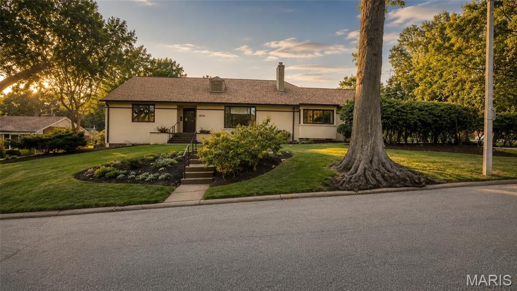 Built in 1948 and transformed by a 1991 addition that doubled its footprint, this Oakbrook Forest ranch delivers a scale almost never found on one level: 8,006 total finished square feet on nearly half an acre in University City, minutes from Clayton and I-70. Six bedrooms, three full and four half baths, two full kitchens, and an oversized 3-car garage with rear entry. Five bedrooms sit on the main level, including a primary suite with its own sitting room/office, whirlpool bath, double sinks, and separate shower, plus a small adjoining room that works as a nursery or second walk-in closet. The main floor also holds the living room, separate dining room, family room with woodburning fireplace, a 15x16 eat-in kitchen with custom cabinetry and solid surface counters, and a laundry/mudroom. Front and back staircases. A sixth bedroom or private office occupies the second floor. The finished lower level is the surprise: a 25x47 bonus room with exercise platform, previously built out as a professional audio and video production studio, plus a second full kitchen opening to its own 36x15 recreation room, two half baths, and a second laundry. It functions as genuinely separate living space. Three independent HVAC systems. A 200 sq ft cedar-lined closet. Built-in bookcases, walk-in closets, bay and atrium doors, in-ground sprinkler system, screened in porch. The expensive items are already handled: complete roof replacement in 2023, new water heater, new dishwashers.