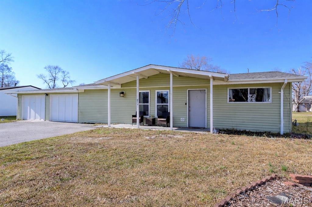 Welcome home to this charming ranch offering easy, no-step entry and comfortable one-level living! Relax on the covered front porch before stepping inside to a bright, open floor plan featuring a spacious living and dining room combination — perfect for everyday living and entertaining. The updated kitchen shines with new cabinetry, stylish backsplash, and newer laminate flooring, providing both function and modern appeal. Original hardwood floors add timeless character in the bedrooms, while the convenient main-floor laundry/mud room adds everyday practicality. You will also be impressed by the updated bathroom. Outside, you will love the large, level fenced backyard — ideal for pets, play, or gatherings. The oversized 2-car garage offers exceptional storage and workspace potential. Located just minutes from Arnold Park, this home combines comfort, convenience, and value in a desirable location. Don’t miss this opportunity for easy living in a great setting!