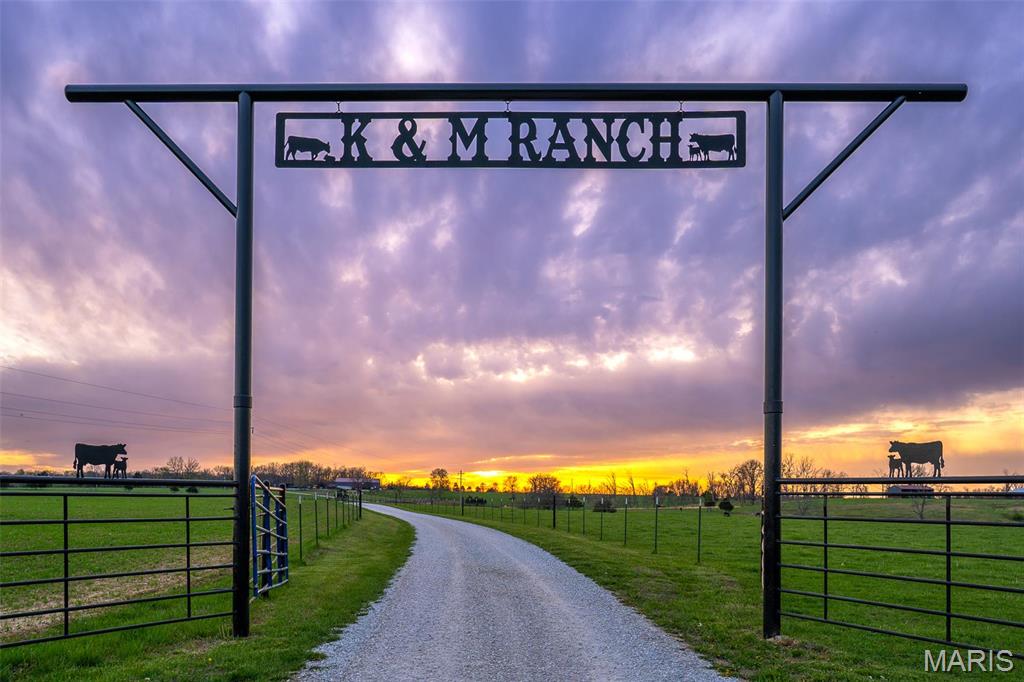 Welcome to K&M Ranch.  A turn-key working cattle ranch calving operation in a beautiful Ozark Mountain setting of Southwest Missouri.  This income generating ranch consists of two separate parcels (main ranch home place 178 acres and the hay production ranch 220 acres located less than 1 mile down the road) total of 398 acres.  At the main ranch homestead, there is a highly productive calving operation with return-on-capital for that rancher seeking an income producing job.  The operation currently supports 90-120 cows and 5-8 bulls, which produce around 125 calves per year.  The facilities are top notch, clean, and free of needed any improvements other than ongoing maintenance and up keep.  There is a residence at the main homeplace along with equipment shed, barn, and machine shop.  There are numerous pastures fenced and cross-fenced and a feed lot for calves.  The ranch is self-sustaining with hay production and forage grasses harvested annually to support supplemental feeding.