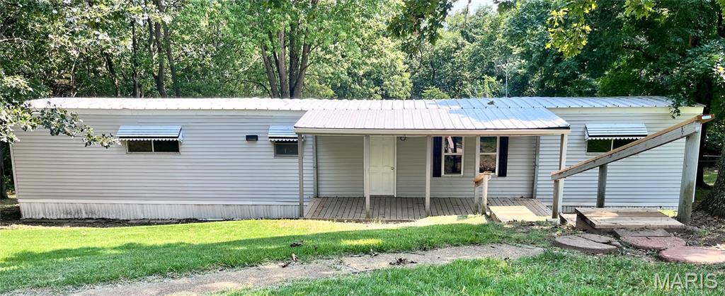 Welcome to this charming 2-bedroom, 1-bath home nestled in De Soto! Offering a great combination of comfort, updates, and outdoor space, this property is ready for its next owner. Inside, you'll find drywall throughout, new flooring, attractive 6-panel doors, and an inviting electric fireplace that creates a warm focal point in the living area. The versatile bonus room provides valuable additional living space with endless possibilities for a dining room, home office, hobby room, sitting area, or entertaining space. Recent improvements offer added peace of mind, including an HVAC system replaced in 2025, new french door, a durable metal roof, and a new metal roof on the porch and bonus room. Outside, enjoy the privacy of a fenced yard, a convenient circle drive, and additional parking for guests, vehicles, or recreational toys. With just at an acre of land, there's plenty of room to garden, play, entertain, or simply enjoy the outdoors. The property features public water and septic. Combining practical updates, flexible living space, and a generous lot, this property offers a wonderful opportunity to enjoy comfortable living with plenty of room to make it your own. Don't miss your chance to see all this property has to offer!