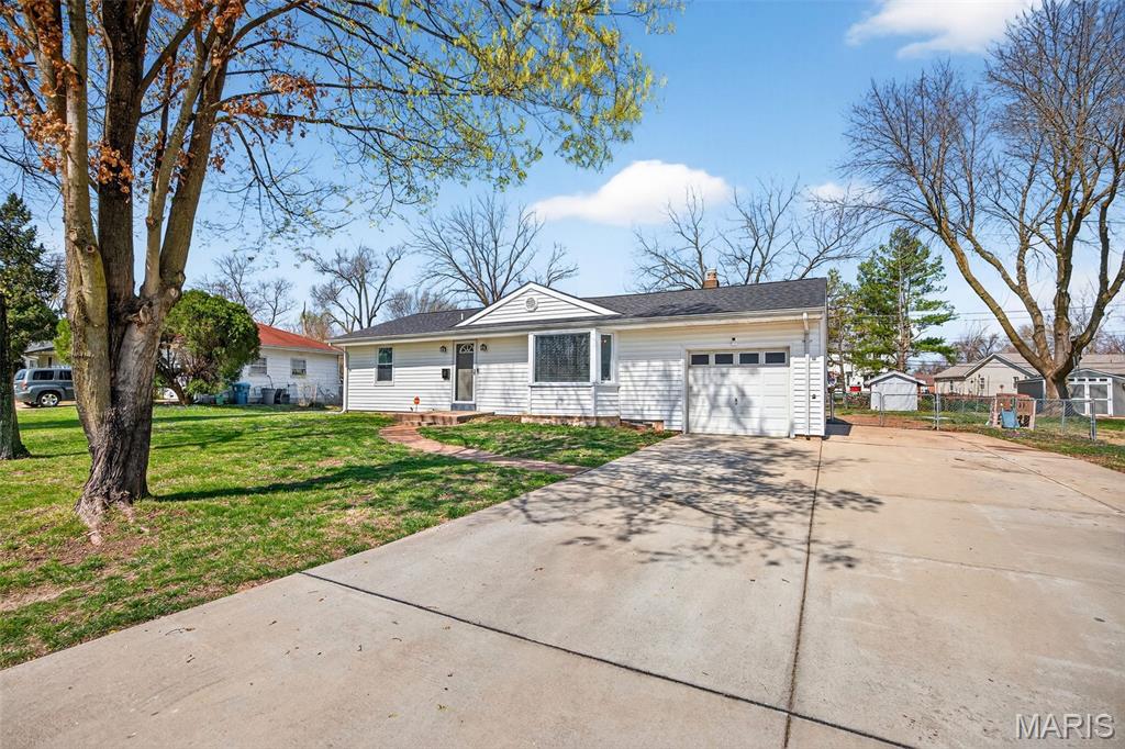 PRIDE OF OWNERSHIP shines throughout this spacious and well-maintained 4 bedroom, 1.5 bath home. Upon entering you will notice the newer luxury vinyl plank flooring throughout and a spacious living room that leads into the dining/kitchen area. The kitchen then seamlessly flows into the living area, allowing for easy movement and entertainment. Prepare meals with ease in the well-appointed kitchen, which offers stainless steel appliances, ample counter space and a custom breakfast bar. After your meal, gather with loved ones in the huge family room around the custom-built electric fireplace. Finally, step outside to the spacious semi-private patio or enjoy the expansive level lot. Additional updates include beautifully remodeled bathrooms, new roof in 2024, new HVAC in 2023 and newer driveway with extension in 2019. Located close to parks and in a well-established neighborhood.