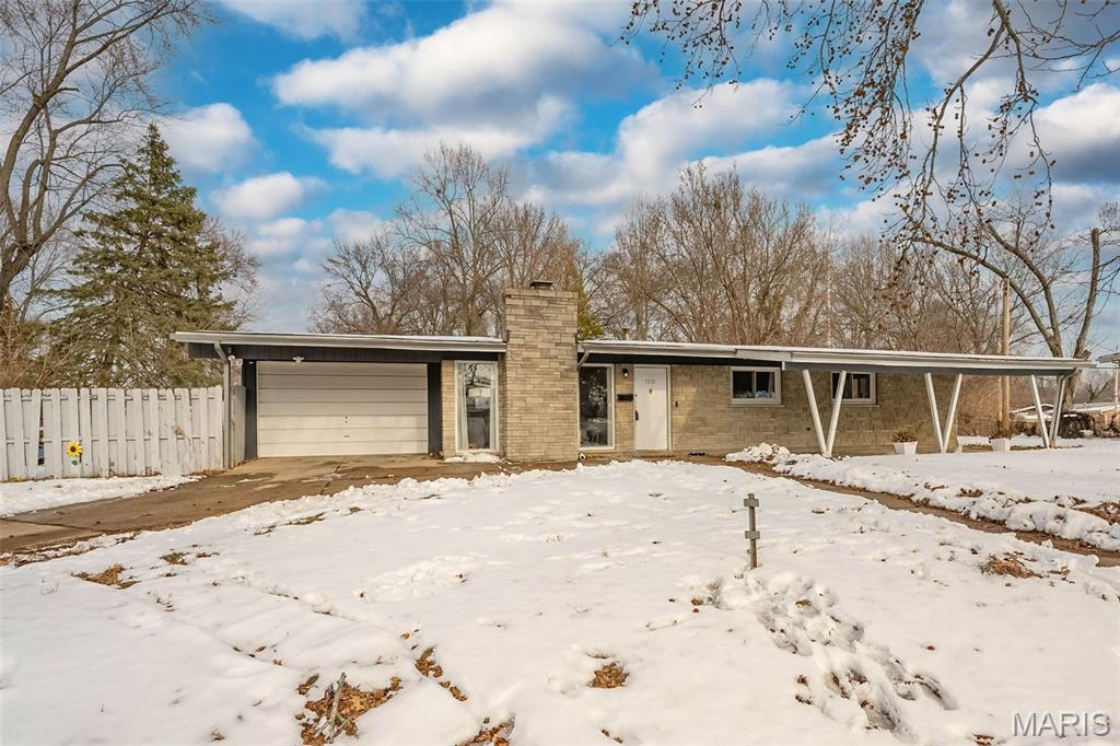 Modern updates, an open layout, and easy one-level living come together in this beautifully updated 3-bedroom, 2-bath ranch. The heart of the home features a fully renovated kitchen with crisp white shaker cabinetry, quartz countertops, stainless steel appliances, and a generous center island—perfect for casual meals, hosting friends, or late-night takeout sessions. The spacious living area is filled with natural light and highlighted by vaulted ceilings, recessed lighting, luxury vinyl plank flooring, and a cozy wood-burning fireplace that anchors the space. Both bathrooms have been thoughtfully updated with clean, modern finishes, creating a cohesive and polished feel throughout. Updated HVAC, plumbing, and water heater add peace of mind, while the fenced yard offers space for pets, play, and summer gatherings. A carport plus garage provides convenient parking and extra storage. Stylish, thoughtfully updated, and designed for easy everyday living! Stop scrolling and start packing - it won't last long!
