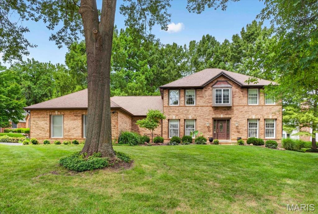Beautiful full brick front home built by The Jones Company. This 1.5 story home has a unique floor plan with 2 master suites. One on the upper level and one on the main level. Great for mother-in-law suite or live-in nanny. There is a spacious kitchen with center island and a large laundry room. The main level master suite has two closets, one walk-in and a full bath with separate tub and shower. There are 2 additional bedrooms, could be 3 if you add a closet to that one. There is a formal living, dining room and a family room with fireplace and a big bay window. Enjoy your morning coffee in an all glass sunroom. Two AC and two furnaces, 3 car garage and nicely landscaped yard with treed lot...Come look a this great family home!