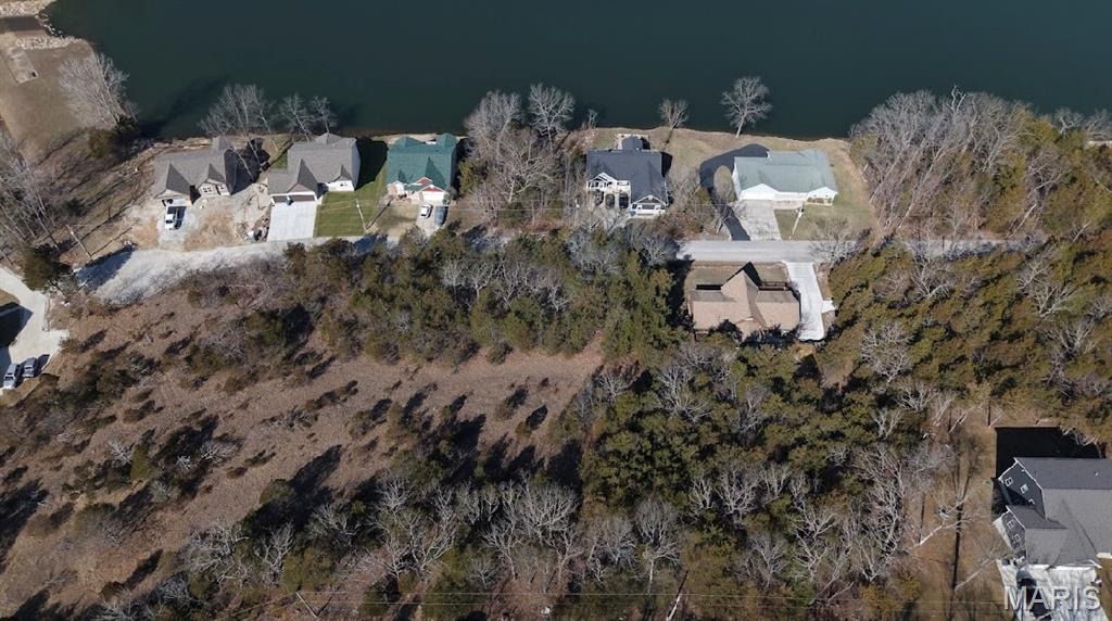 Lakefront Living at Its Finest!  This sub waterfront, buildable lot with breathtaking views offers a perfect canvas for your next dream home right next to new construction. You’ll enjoy convenience and tranquility located just 5 minutes north of Hillsboro and 30 minutes from Greater St. Louis. This is more than just land—it’s a lifestyle.  Amenities include four lakes, a white, sandy beach area, campgrounds, golf courses, swimming pool, fitness center and more. Feel free to explore this amazing opportunity and create your scenic fun-loving lakeside retreat!