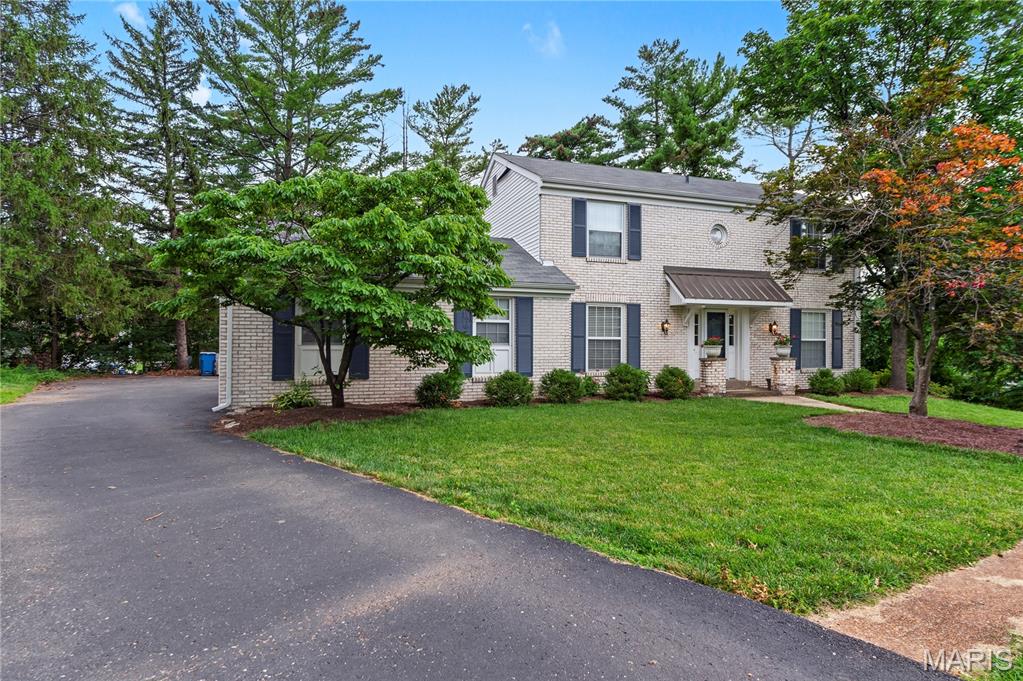 Welcome to this charming 4-bedroom, 2.5-bath two-story home located on a private cul-de-sac ideal for easy hockey or basketball games, offering gorgeous curb appeal in the prestigious and sought-after Whispering Oakwood neighborhood of Ballwin. This tight-knit community is perfect for growing up, highlighted by the annual Soap Box Race that remains a true neighborhood favorite. Step inside to a light and bright kitchen featuring stainless steel appliances and granite countertops that flows seamlessly into the hearth room, complete with a wood-burning fireplace and French double doors opening directly to the beautiful paver backyard. All bathrooms have been timelessly updated in gorgeous rich carrara tiles. Recent improvements include a new roof in 2023, a furnace replacement in 2025. Tthe addition of a basement office in 2024, and the creation of the paver patio in 2025 after the previous deck was removed have all been lovingly and carefully added by this owner.. The lower level offers partially finished space with the office along with laundry and additional storage in the unfinished area.