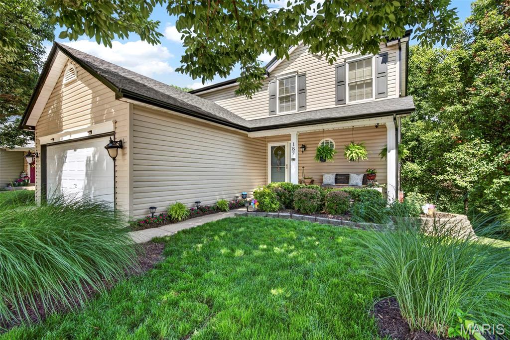 If you are looking for a home with serenity inside and out and close to everything you could need, then this is a house you have to see!

The yard backs to tree lined common ground and your back deck sits up among the tree tops providing an incredible place to enjoy a calm morning cup of coffee or entertain family and friends on beautiful summer evenings. A luxury view and premium feature on a unique lot for this neighborhood.

Inside, the open-concept main level gives the home a natural, easy flow with the kind of layout where conversation carries from the kitchen to the living room without anyone feeling left out. The built in speaker system, inside and out, will up your entertaining game a notch!

Upstairs you'll find 3 bedrooms including a primary suite with custom shelving walk-in closet, double vanity, shower and soaking tub. In addition to the second floor full bath, you will find a homework nook tucked at the top of the landing.

An incredible feature of this home is the fully self-contained suite in the walk out basement with one bedroom, luxury full bath, living space with fireplace, and complete kitchen. It's a perfect place for a parent who wants to be close but still have their own space, a landing spot for a returning college kid or a guest setup that doesn't feel like a compromise. Whatever your life looks like right now, this home has room for it.

Inside and out, this home is well maintained and updated including a new roof, gutters and partial siding just this year. Zoned heating and cooling keep your bills down and comfort high. All major worries taken off your list so you can focus on the details of making this your home.

The amenities of the Homefield Gardens neighborhood are icing on the cake. Two pools, walking trails, basketball courts, a fishing lake, disc golf, and two picnic pavilions. It's the kind of place where neighbors become friends. Plus you have the benefit of the top ranked Fort Zumwalt School District. Schedule your private tour soon!