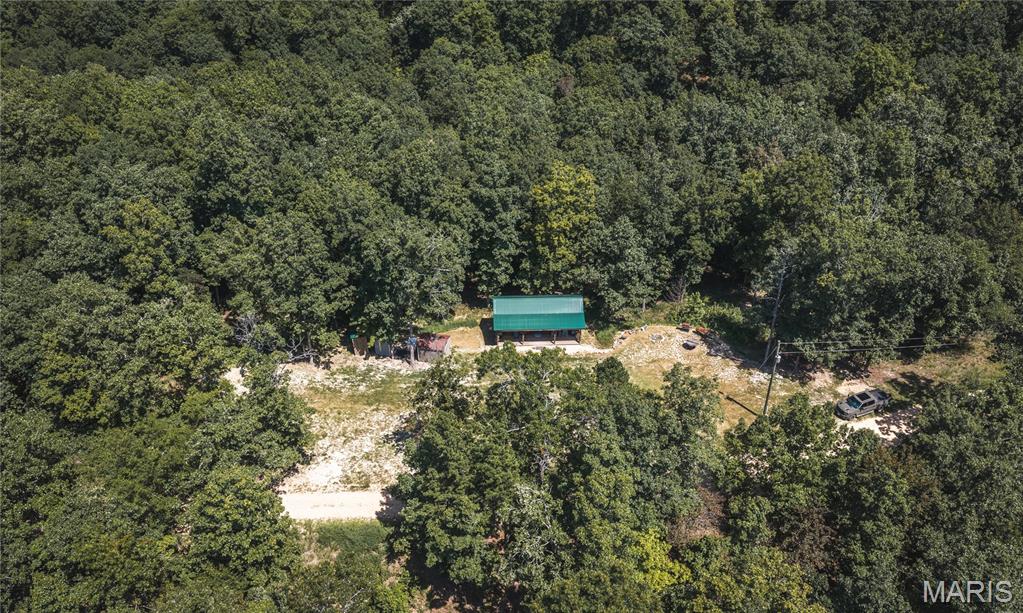 Escape to the foothills of the Missouri Ozarks with this exceptional 12-acre property just outside Annapolis and only minutes from the Black River. The 448 sq. ft. cabin offers the perfect getaway with 1 bedroom, 1 bathroom, a cozy kitchen, metal roof, and a spacious covered porch overlooking the peaceful surroundings. Outdoor recreation is at your doorstep, with the Black River nearby offering excellent fishing and floating opportunities. The river is known for healthy smallmouth and largemouth bass, making this an ideal location for anglers and water enthusiasts. The surrounding area also provides abundant opportunities for ATV and UTV riding, hunting, and exploring. Whitetail deer, turkey, squirrels, and other wildlife are plentiful throughout the region. The property is also set up for friends and family to join in the fun. A camper hookup with well and septic is already in place, providing a convenient additional camping spot. There is also a separate shower house, giving guests extra space and comfort during extended stays. Whether you're looking for a private weekend retreat, hunting and fishing camp, family getaway, or a place to enjoy the great outdoors, this 12-acre property offers the perfect combination of comfort, recreation, and Ozark beauty.