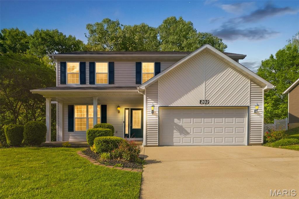 Beautiful 2-story home featuring 4 bedrooms, 4 baths, and a 2-car attached garage, perfectly situated on a lot backed to woods for some privacy. The main level offers an updated kitchen with quartz countertops, center island, electric range with gas hookup, and both an eat-in area and separate dining room—ideal for everyday living and entertaining. The open living room includes a cozy gas fireplace and the eat-in kitchen flows seamlessly into a stunning sunroom with heating and cooling, creating the perfect year-round retreat for morning coffee or relaxing evenings. Outside, enjoy the fenced backyard backing to woods and a composite, maintenance-free deck designed for low upkeep and outdoor enjoyment. Covered patio adds to additional entertainment area. Zoned HVAC (2020) provides comfort and efficiency throughout the home. Upstairs features 4 spacious bedrooms, skylights for natural light, and convenient washer/dryer hookup. The primary suite offers a walk-in closet, whirlpool tub, and separate shower. The finished basement expands your living space with a family room, bonus room, full bath, laundry area, and a dry bar with water hookup—perfect for entertaining or flexible living needs. Located in a quiet neighborhood with easy access to St. Louis and Scott Air Force Base, and close to schools, dining, and shopping—this home checks all the boxes!