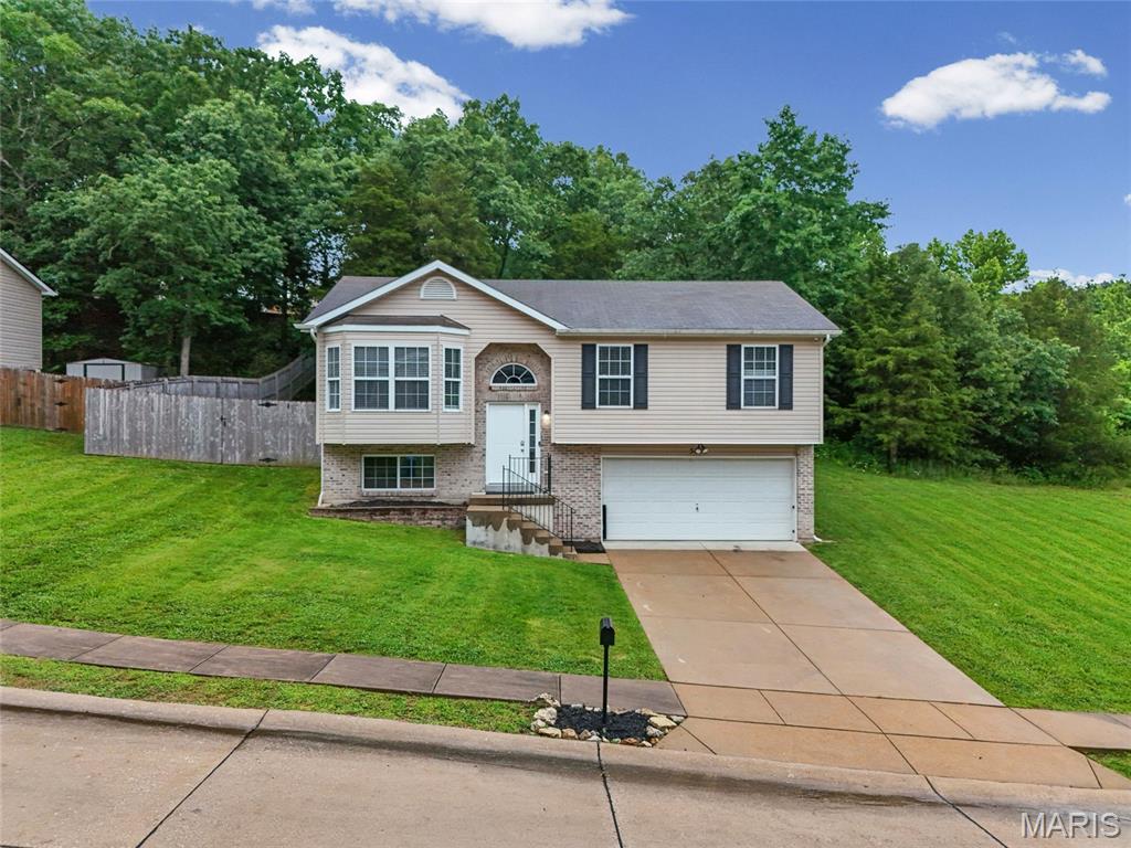 USDA FINANCING AVAILABLE for this UPDATED & READY for new owners.  This move-in-ready 3-bedroom, 2-bathroom home in Hillsboro, in a family-friendly subdivision, is looking for new owners.  The home features a fantastic open floor plan, including a large living room with a vaulted ceiling, a large bay window, and luxury vinyl plank flooring. It extends to the large kitchen with lots of 2-panel custom dark wood cabinets, backsplash, and electric appliances, including a new fridge, and updated lighting.  The primary bedroom features vaulted ceilings, new paint, luxury vinyl plank flooring, a walk-in closet, and a private bath with a large shower.  Bedrooms 2 & 3 are also freshly painted, with new paint, fresh trim, and luxury vinyl-plank flooring.  Off the kitchen is an oversized 15 x 24 aggregate patio with a large gazebo overlooking a huge yard with a 6' privacy fence, lots of trees for shade, and an oversized gate. The lot is adjacent to the entry, so no worries about any neighbors on the right side of your home.  The lower level has an oversized recreation room, laundry, and an additional room with rough-in bathroom features, plumbed but easy to complete.  Go through to the oversized garage with a garage door opener, freshly painted walls, and extra storage space.  Minutes from schools, stores, restaurants, entertainment, and highway access. Six-foot fence installed in 2020, water heater ew 12/2025, new fridge 10/2025. This is a great first home for someone! USDA financing available - No money down for an eligible buyer!!  NEW ROOF BEING INSTALLED 6/9/26
