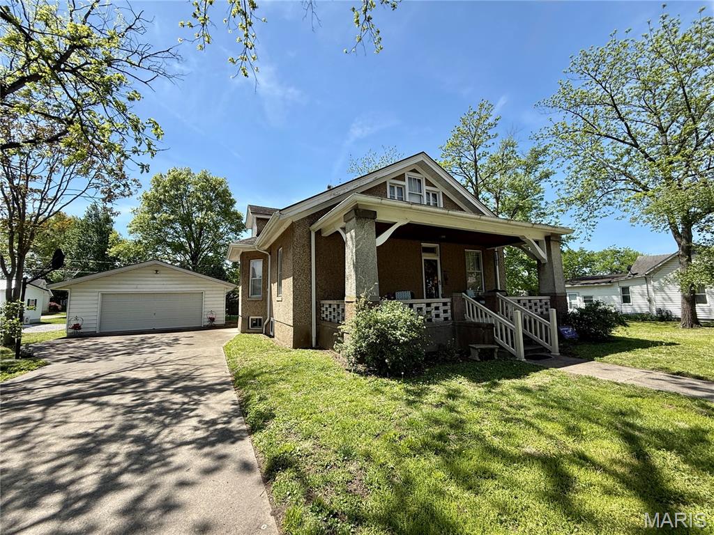This beautiful 1920's Craftsman style bungalow has been loved and meticulously maintained. They really just don't build them like this anymore! Solid construction, charming details, and coziness that is hard to put into words. In-person tours are highly encouraged to fully appreciate this property. Original hardwood floors and trim work throughout are in excellent condition. The large front porch is perfect for welcoming guests, and enjoy the peaceful breeze on the screened rear porch. The updated kitchen features a lovely butlers pantry with convenient main level laundry. The upper level is mostly unfinished except for the north room, but offers great potential for additional living space. The basement provides excellent storage space - and let's not forget the spacious 4-car garage with rear overhead utility door. High quality metal shingle roof installed in 2013. Schedule your tour and start checking off your house-hunting wishlist!