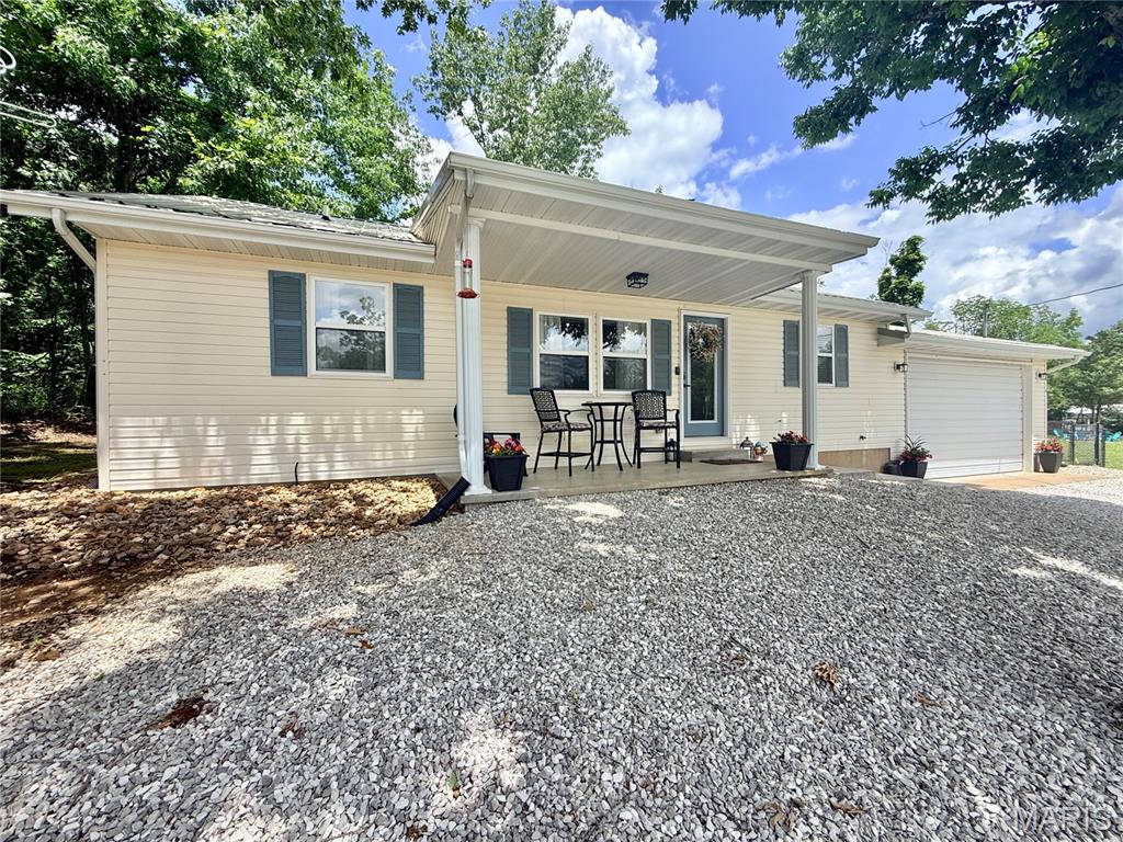 Located in the gated community of Lake Perry, this adorable ranch-style home offers the perfect blend of comfort, recreation, and space to enjoy the outdoors! Built in 2003, this well-maintained home features 3 bedrooms, 2 baths, and approximately 1,080 square feet of living area, all situated on a spacious double lot totaling 1.344 acres. Step inside to find an open living, dining, and kitchen layout highlighted by a specialty vaulted ceiling that adds character and an airy feel to the main living space. For stream-lined moving, the kitchen appliances as well as the washer/dryer will stay. The split-bedroom floor plan provides added privacy, while the primary suite features a walk-in closet and a recently remodeled private bath complete with a beautiful walk-in tile shower and rain head fixture. Main-level laundry access from the garage is ideal. Outside, you’ll love the inviting front porch, back patio area, partially fenced yard for furry friends, and plenty of additional parking space for guests and lake toys. A firepit gathering area makes the perfect spot to relax with friends and family after a day at the lake. The attached two car garage includes an automatic opener for added convenience. Lake Perry offers a wide variety of amenities including a community pool, gathering place, playgrounds, picnic areas, beaches, laundry facilities, and access to the lake for boating, fishing, and swimming. Whether you’re looking for a full-time residence or weekend getaway, this property offers the ideal lake community lifestyle!