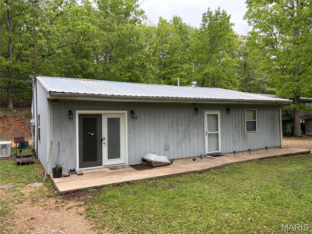 If you are ready to live in nature, then look no further!  2 bed, 1 bath home with a nice open floor plan that is awaiting your personal touches.  Great wooded location surrounded by wildlife.  Property includes a covered patio and deck overlooking a nice, secluded meadow for your enjoyment!  The property also has covered parking for your camper or large toys that could easily be closed in.