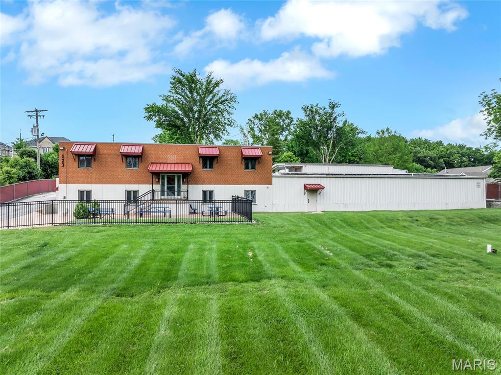 Excellent opportunity for commercial use at 123 Cliff Cave Rd in St. Louis! This versatile property features an 8,080 sq ft warehouse with office space and 4 bathrooms, plus a 1,500 sq ft outbuilding/shed with a large covered parking port—ideal for equipment or vehicle storage. The lot offers approximately 20 parking spaces and is fully fenced with a gated entry for added security. Solar panels provide energy efficiency and potential cost savings. Conveniently located with ample space for operations, storage, and staff. Don’t miss this unique chance to own a secure and functional commercial property! Position your business for success with this versatile and well-maintained property. Sale is subject to completion of parcel subdivision (Parcel #31H-12-0405).
