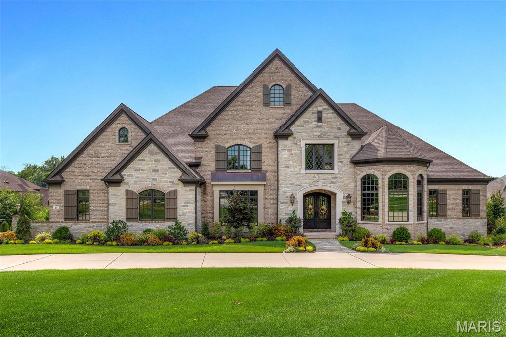 This exquisite European-inspired Estate from Monterey Custom Homes features exceptional craftsmanship, superb architectural finishes & designer lighting. Extraordinary 8’ wrought iron double doors lead to grand 2-story marble foyer highlighted by sweeping staircase, well-appointed study, coffered dining room & spectacular great room with 12’ box beam ceiling, floor-to-ceiling stone fireplace, wet bar & wine cellar. Spectacular kitchen with 46” custom cabinetry, professional grade appliances & dual 14’ center islands adjoins breakfast room with atrium door to veranda. Primary bedroom suite with wide bay window & marble bath with shower spa offers an appealing retreat.  Front & rear staircases access 3 additional bedrooms with ensuite baths & bonus room. Walk-out Lower Level showcasing wide plank hardwood flooring, includes recreation room with 12’ wet bar & family room with stone fireplace plus fitness room, 2nd laundry & full bath. Impeccably landscaped 1.3-ac grounds with veranda, lanai, resort style pool & 4 garage spaces.