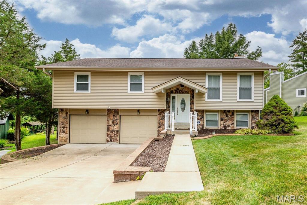 Tucked among mature trees in the heart of Lake St. Louis, this spacious 3-bedroom, 2.5-bath home offers timeless architectural character, generous living spaces, and endless potential to make it your own. From the moment you step inside, you'll be welcomed by soaring vaulted ceilings accented with striking exposed wood beams, creating an airy, inviting atmosphere throughout the main living areas. Sunlight pours through oversized windows into the expansive living room, while the adjoining dining room provides the perfect setting for holiday gatherings and everyday meals alike. The spacious kitchen offers abundant cabinetry, ample prep space, and a functional layout that flows effortlessly to the screened-in deck—an ideal spot to enjoy morning coffee, evening conversations, or peaceful views of the beautifully landscaped backyard. A second screened patio out the walkout lower level expands your outdoor living options and creates the perfect space to relax in every season. The private primary suite features an en-suite bath, while two additional main-level bedrooms provide comfortable accommodations for family or guests. Downstairs, the expansive walkout lower level is anchored by a stunning floor-to-ceiling stone fireplace and offers incredible flexibility for entertaining, game nights, a media room, home office, or multi-generational living. A full bath, and dedicated laundry room complete the lower level. Outside, you'll appreciate the oversized driveway, mature landscaping, and peaceful setting, all nestled within one of Lake St. Louis' most established neighborhoods. Lake access includes a boat slip in the marina or when available the boat slips down the street. Just minutes from shopping, restaurants, parks, golf, major highways, and Lake St. Louis amenities, this home offers the rare opportunity to enjoy exceptional space, distinctive architecture, and a location you'll love—all while adding your own personal style over time. This is more than a house—it's a home filled with warmth, character, and endless possibilities.