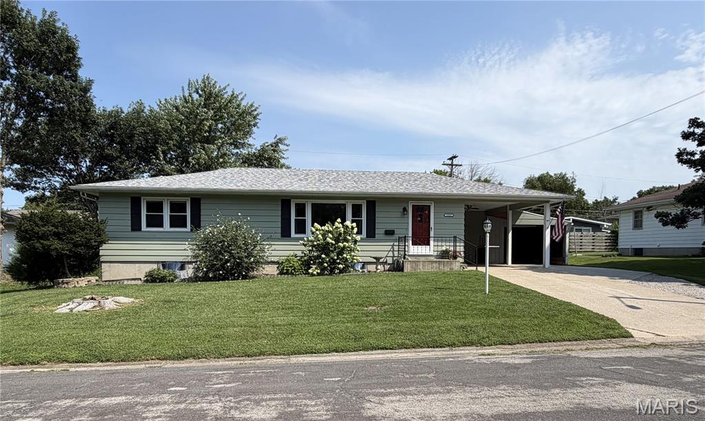 THIS is the one you’ve been waiting for! From the moment you step inside, you’ll fall in love with the charm, space and pride of ownership throughout this wonderfully maintained home! Gorgeous original hardwood floors set the tone, while the HUGE living room steals the show with an oversized picture window flooding the space with natural light. The kitchen is ready for everyday living and entertaining with Corian countertops, stainless steel appliances and a breakfast bar perfect for morning coffee or quick meals. The main level offers 3 generously sized bedrooms and a fantastic full bath featuring a double-bowl vanity, tile backsplash and ceramic tile flooring. But there’s even more downstairs! The partially finished lower level delivers a massive 4th bedroom, large family room, second FULL bath and workshop—giving you tons of extra living, entertaining and hobby space! Whole house water softener and water filtration. Now step outside because THIS BACKYARD IS AWESOME! The large patio offers plenty of room to entertain, complete with a pergola AND covered sitting area, while mature trees and a fenced yard create your own outdoor retreat. Summer BBQs, evenings with friends or a quiet morning coffee—this backyard was made to be enjoyed! HUGE oversized driveway, covered parking and plenty of storage for all of your outdoor needs. And the location? Hard to beat! Tucked away on a quiet dead-end street, close to the YMCA and within walking distance of beautiful Lakeview Park. Great space, gorgeous hardwoods, an incredible backyard and a fantastic location—come see why this one feels like HOME!