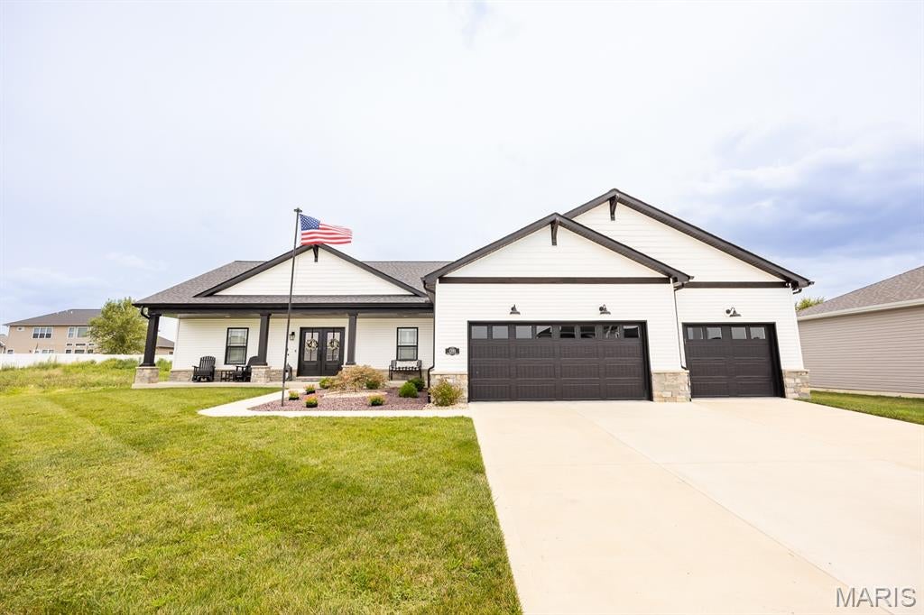 WELCOME HOME TO THIS STUNNING, PRACTICALLY BRAND-NEW CUSTOM FARMHOUSE-STYLE RANCH, THOUGHTFULLY DESIGNED WITH BEAUTIFUL FINISHES, LOTS OF UPGRADES AND AN OPEN FLOOR PLAN. Located in the desirable Reserves of Timber Ridge, you will love that this home is ready now instead of waiting to build. The main level features plantation shutters, an inviting electric fireplace with custom built-ins and lighting, and a spacious kitchen complete with gas range, smart appliances and an impressive walk-in pantry. Down the hall from the kitchen is a big laundry room with mud sink, closet and lots of cabinet space. The primary suite is on the opposite side of the house and offers direct access to the back yard, a spa-like bath with a walk-in tiled shower and a custom walk-in closet with built-in organization and an island. Two additional bedrooms share a bathroom in the hallway and there is also a dedicated built-in office area in one of the closets. The finished lower level takes this home to another level with a second electric fireplace, wet bar with refrigerator and microwave, rec space that includes space for a golf simulator and a shuffleboard game (included), sauna, another bedroom and another full bathroom. There is still plenty of unfinished space for storage, a sump pump and a radon mitigation system already installed. Additional highlights include an oversized three-car garage with epoxy flooring, screened-in porch, patio plumbed for gas and an in-ground sprinkler system. This home is perfect for entertaining and ready for a new owner! MUST SEE!