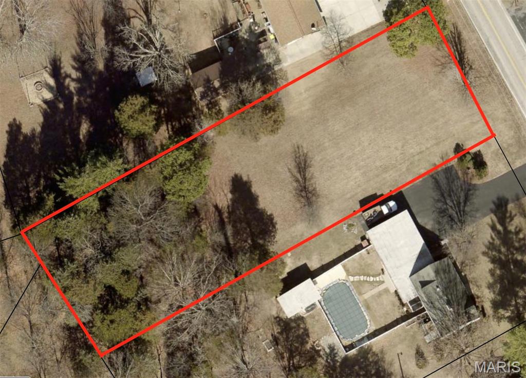 Large, level building lot offering a great mix of privacy and convenience. Just minutes from shopping, schools, parks, restaurants, and entertainment, with easy access to Highway 67 and I-55 for an easy commute. Located on a county road, the property backs to woods and mature trees, providing added privacy and a peaceful setting. City water, city sewer, and electric are available, making it easy to start building. A great opportunity to design and build your dream home!