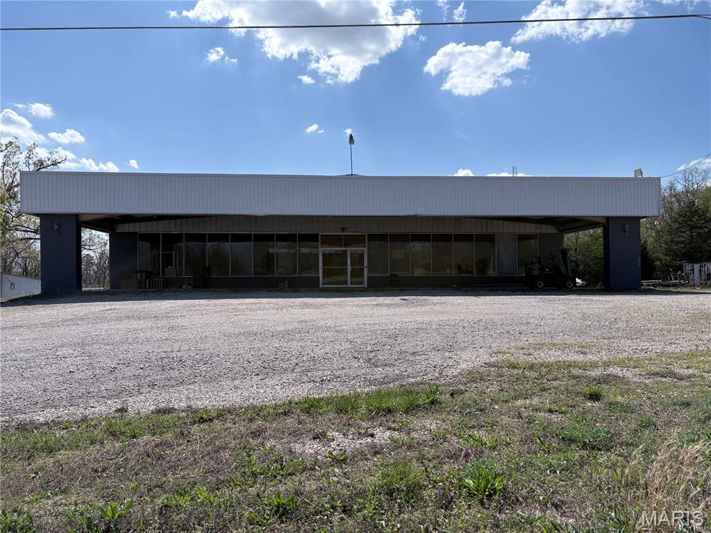 Positioned just north of Poplar Bluff, this versatile commercial property offers exceptional visibility and easy access right off the highway, making it an ideal location for a wide range of business opportunities. The main level features approximately 6,000 square feet of open space, complete with a dedicated office area and restrooms. The expansive layout provides endless potential for retail, warehouse, showroom, or service-based operations. The lower level adds an additional 2,800 square feet and includes three bay doors, creating excellent functionality for storage, distribution, light industrial use, or automotive-related businesses. Situated on 1.7 acres, the property offers ample room for parking, expansion, or outdoor operations. With its high-visibility location and flexible layout, this property is a rare opportunity for investors or business owners looking to grow or establish a presence in a high-traffic area. Don’t miss the chance to unlock the full potential of this well-located commercial space.