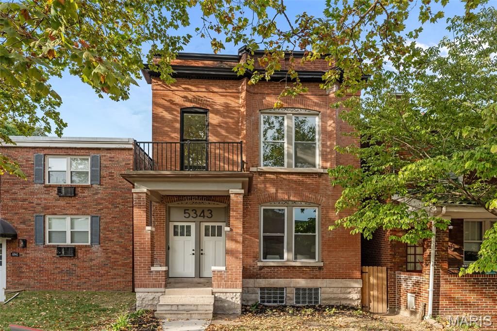 Welcome to this beautifully renovated century home in St. Louis's Southwest Garden neighborhood, just blocks from Sublette Park and Tower Grove Park! You'll have great curb appeal with a brick exterior shaded by large trees, and a covered porch. Inside, you'll find a wonderful blend of historic charm and modern updates. The foyer leads to the bright living space, featuring gleaming hardwoods, exposed brick, and 10-foot ceilings, along with recessed lighting, a stylish chandelier, and an open layout. Enjoy hosting gatherings in the spacious dining room and kitchen, complete with 42" cabinets, quartz counters, stainless steel appliances, black fixtures, a breakfast bar, and timeless subway tile backsplash. Beyond is a bedroom suite, with exposed brick detail, updated bathroom with a double sink and gorgeous tile-surround tub. A half bath completes the main level. Upstairs, the primary suite features a walk-in closet, new LVP flooring, and a luxurious bathroom with a jet tub, step-in tile-surround shower, and its own private balcony overlooking the backyard. You'll have two more bedrooms, one with a lovely decorative fireplace, as well as another updated full bathroom, and convenient laundry room with access to the front balcony. A walk-up unfinished basement adds storage space. Enjoy the last days of summer on the patio overlooking the fenced backyard. You'll have off-street parking in the alley-access garage. A new garage door will be installed prior to closing. In a great location just moments from all the restaurants on The Hill, nearby parks, schools, and shopping, plus quick access to I-44 and Downtown St. Louis, this home is one you won't want to miss!