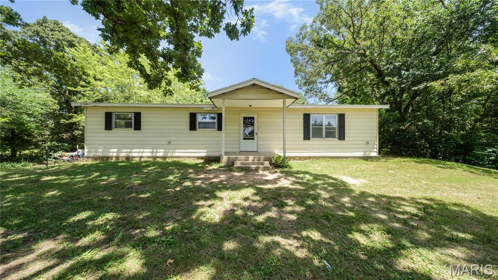 Enjoy the perfect blend of modern updates and peaceful country living with this beautifully updated 3-bedroom, 2-bath home situated on over 5 private, mostly wooded acres in Newburg with convenient interstate access. Step inside to find new luxury vinyl plank flooring, updated lighting, and new kitchen appliances, creating a fresh, move-in-ready interior. The new central heating & cooling system will provide peace of mind. The partially finished walkout basement offers endless potential for additional living space, complete with a second kitchen, full bathroom, and laundry hookups. Outside, unwind on the covered front porch or explore the scenic wooded path leading to a picturesque pond, where you'll enjoy abundant wildlife and a tranquil setting. A detached one-car garage provides extra storage and workspace. Whether you're looking for a private retreat or a home with room to grow, this property offers the best of both worlds. Schedule your private showing today!