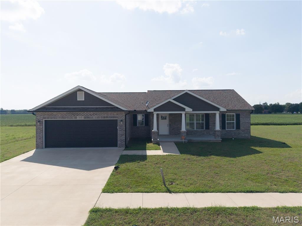Welcome to 315 Citation Drive in Sikeston’s Saddleridge South! This beautifully designed home offers an inviting combination of comfort, style, and functionality. Vaulted ceilings and an open floor plan create a spacious feel, seamlessly connecting the living, dining, and kitchen areas for easy everyday living and entertaining. The kitchen features granite countertops, stainless steel appliances, ample workspace, and convenient access to the main living areas. Stylish luxury vinyl plank (LVP) flooring complements comfortable carpeting in the living area, dining area, and bedrooms, providing an attractive combination of durability and warmth throughout the home. The spacious primary suite offers a relaxing retreat with a walk-in closet and private en-suite bath featuring a double vanity, jetted tub, and separate shower. Additional bedrooms and living spaces provide flexibility for a variety of needs. Outside, enjoy the welcoming covered front porch and rear patio—perfect for relaxing, grilling, or entertaining. Located in Saddleridge South, 315 Citation Drive offers attractive finishes, a functional open layout, comfortable indoor and outdoor living spaces, and a great opportunity to make this Sikeston property your next home.