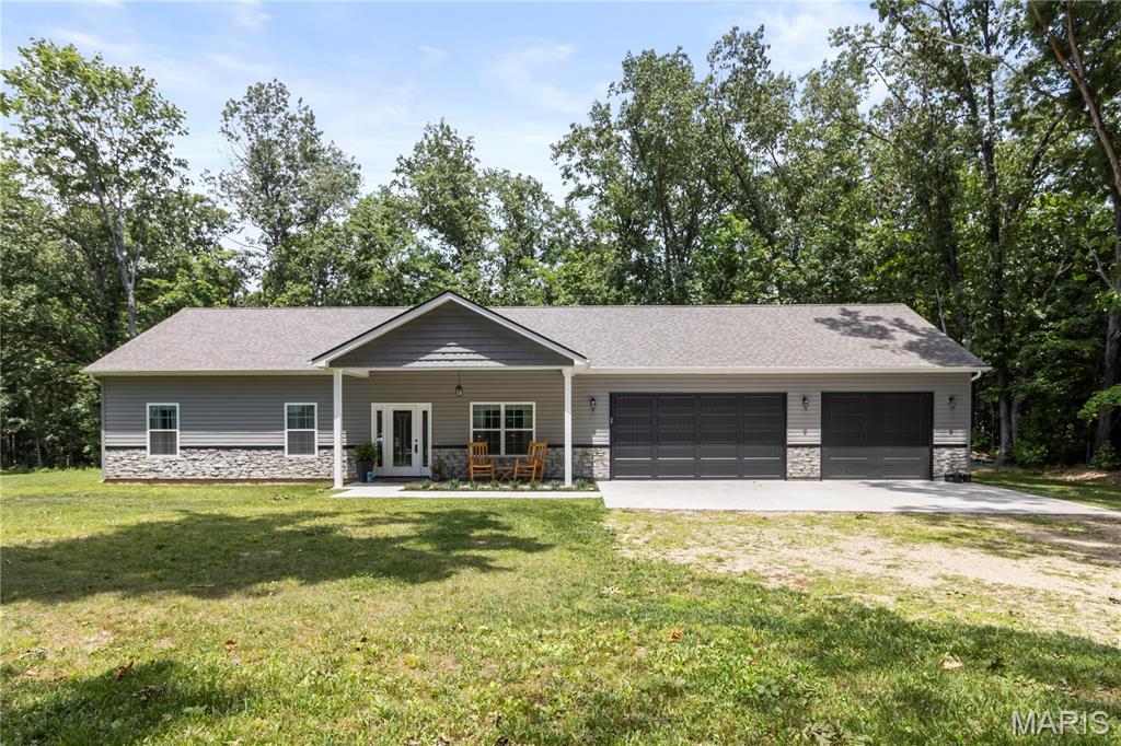 Welcome to this stunning nearly-new home, just 2 years old, perfectly situated on a desirable corner lot surrounded by a peaceful wooded backdrop. This property offers the ideal blend of modern design, privacy, and everyday functionality. Step inside to discover a bright contemporary interior featuring an open-concept with stylish finishes throughout. Outside, enjoy the beauty of nature with mature trees providing a serene setting. Don't miss the opportunity to own this beautiful gem that combines modern living with a tranquil setting.