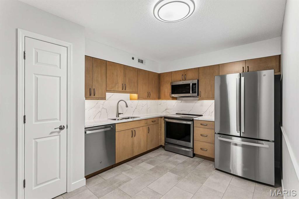 Rare First-Floor Luxury Condo with Dedicated Office ! Welcome to a completely re-imaged, Move-In-Ready, oasis that perfectly blends modern high-end finishes with ultimate convenience. Situated on the highly desirable ground floor, this unique, one of a kind, 2B/2B layout boasts an incredible floor plan featuring a dedicated private office space---perfect for working from home. Premium Interior Upgrades Include: Gourmet Kitchen: Sleek modern cabinetry, gorgeous custom quartz countertops with matching full-height backsplash, and LED ambient illumination. Equipped with all-new GE stainless steel appliances (including microwave and oven with built-in air fryers). Sophisticated Bathrooms: Designer floating vanities topped with custom quartz, adult-height toilets, and beautifully detailed tub/shower surrounds. Modern Essentials: Premium, durable LVT tile flooring flowing seamlessly throughout (no carpet), new energy-efficient patio door and windows, custom window blinds, and updated contemporary lighting. Plus, new full-sized GE washer and dryer stay with the home! The Perfect Location: Nestled in a quiet, secure-entrance enclave at the corner of Big Bend and Hanna Road. Enjoy effortless access to Highway 141, I-44 and Manchester Road. You are minutes from major supermarkets, local dining, and less than 7 minutes from Castlewood State Park and Manchester City Park. Includes an assigned carport space plus ample surface parking. Low maintenance, economical to heat and cool. Enjoy sophisticated living, today !