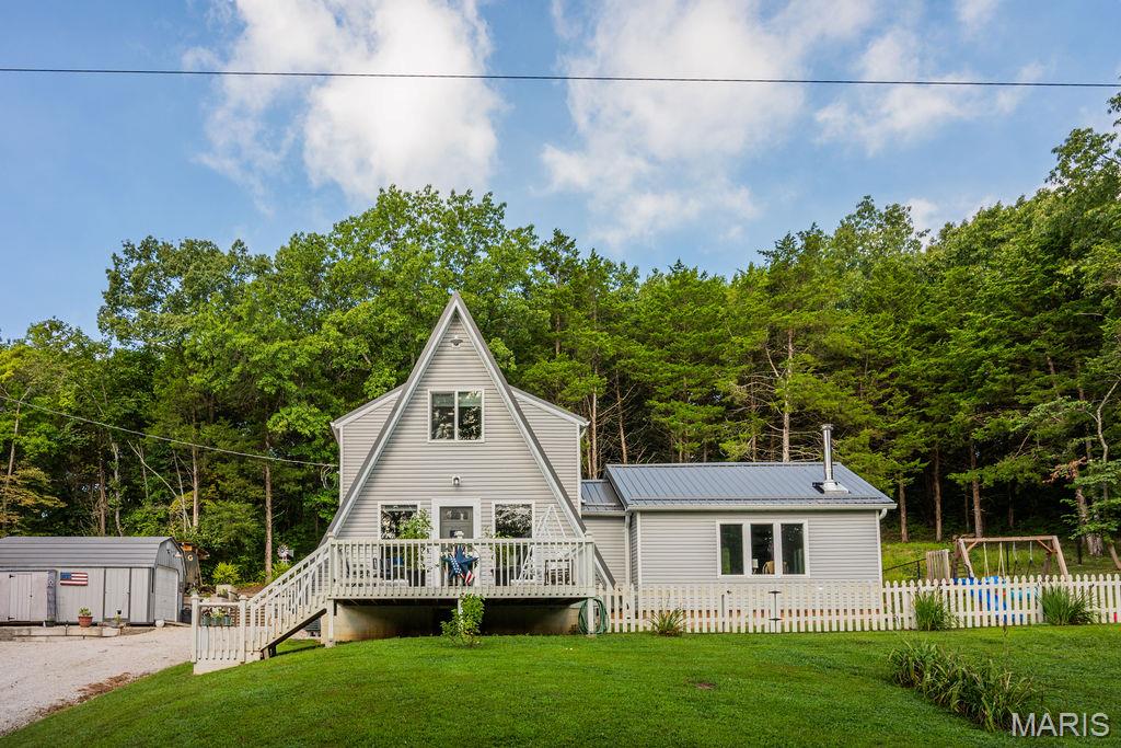 Looking for an adorable home within a great Lake Community? This 2 bed 2 bath house has so much room inside & out for entertaining & relaxing. Nestled in the cute community of Hermit Hollow you will find this home with so many updates. Featuring a large cozy living space with big windows to catch all the wildlife as it walks by. There is a separate dinning room for all your family gatherings which leads you to a great front porch! The back patio is perfect for entertaining and leads into the beautiful kitchen. The upstairs features 2 bedrooms with walk-in closets & a large bathroom. The outside shines all on its own, backing to over 150+ acres of common ground filled with trails & hiking paths! This house has an great swing area up in the woods for you to enjoy your coffee or night time bon fire. Don't forget about the large shed and lean-to ! Last but not least is the amazing 11 acres stocked lake just down the road. This house comes with a newly built dock off the island perfect for enjoying the lake! Looking for a place to have family gathering, fun in the sun, hiking right outside your door, watching nature and privacy all in one, look no further! Call today!
