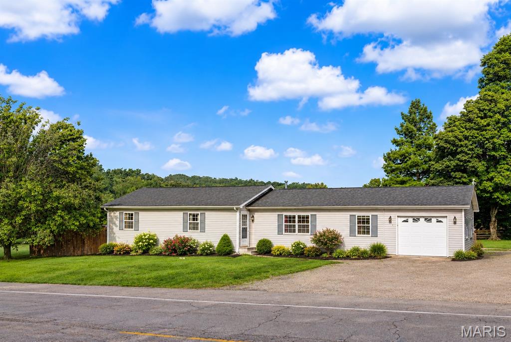 Welcome to this beautifully maintained ranch-style home offering approximately 1,755 sq ft of comfortable living space, ideally located just on the edge of the city limits of Marble Hill. Enjoy the best of both worlds—convenient city utilities paired with the privacy and openness of a stunning 1.76-acre parcel.  This inviting 3-bedroom, 2-bath home features generously sized rooms throughout, highlighted by a gorgeous kitchen complete with striking cabinetry and an eye-catching backsplash—perfect for both everyday living and entertaining.  Step outside to unwind on the spacious covered deck, with plenty of room for a swing, outdoor dining, and relaxing evenings. The backyard is designed for enjoyment, featuring a fenced area with a 27-foot above-ground pool, ideal for summer fun.
A standout feature of this property is the impressive 30x75 shop building, equipped with four overhead doors and a walk-through entrance. With its own separate utilities, this versatile space offers endless possibilities—whether for business, hobbies, or entertaining. Inside, you’ll find areas with central heat and air, water access, a wood stove, two gaming/entertainment spaces, a wash or paint bay, 220-amp service for welding, and airlines installed throughout.  Beyond that, the property continues to impress with a large open field, beautifully tree-lined at the front for added privacy—offering even more space to expand, explore, or simply enjoy the peaceful surroundings.  This is truly a one-of-a-kind property that must be seen in person to fully appreciate everything it has to offer.