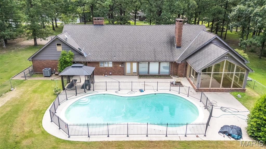 Custom built and designed for comfort and entertaining, this stunning all-brick home offers 5 bedrooms, 4 baths, and sits on 2.5 beautiful acres with the perfect blend of city convenience and a peaceful country feel. Inside, you'll find a formal dining room, a spacious family room with a cozy fireplace, and an inviting all-season room overlooking the sparkling inground pool. The gourmet kitchen features granite countertops and ample cabinetry, while the oversized primary suite boasts its own fireplace, luxurious tile shower, and relaxing soaking tub. With exceptional space, quality craftsmanship, and a private setting, this remarkable property is truly a rare find.