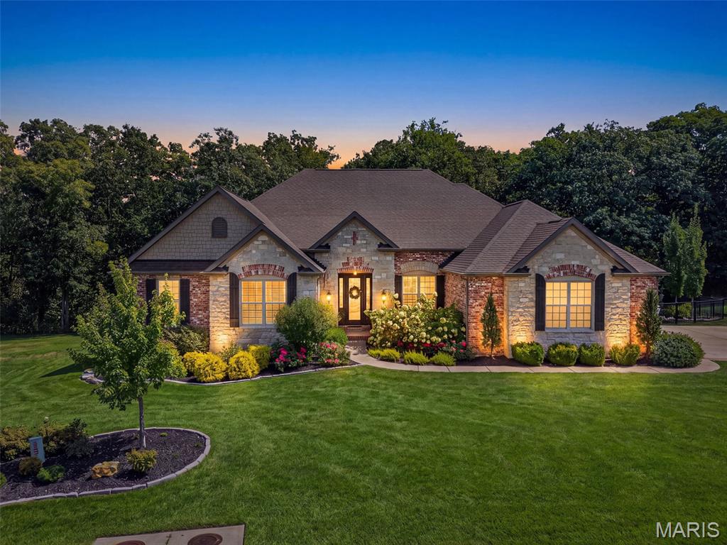 Beautifully designed and thoughtfully upgraded, this exceptional Lombardo Glacier home is situated on a half-acre lot in the prestigious Westleigh subdivision. A wood-beamed tray ceiling and wide plank hardwood floors welcome you in the foyer, setting an elegant tone carried throughout the open-concept main level. The kitchen is a Chef's dream! Appointed with a striking stone arch surrounding the range, an oversized granite island, top-end stainless steel appliances, and a well-equipped butler's pantry featuring a wine fridge. The great room impresses with a floor-to-ceiling stone gas fireplace and serene views of the woods backing the property. The private study, accessed through the 8' French doors, offers a quiet refined space. The expansive primary suite features his and hers vanities and dual walk-in closets with professional closet systems. The walkout basement is equally impressive, designed with entertaining in mind. A custom wood-slat bar with waterfall countertops anchors the space, complemented by a dedicated bourbon room, a basement gym, and game area. A spa-like bath featuring a Clearlight infrared sauna provides a private retreat, while a bonus room doubles as a craft space, complete with a hidden door leading to a concealed safe room. Outside, the backyard delivers a resort-like experience, centered around a 26,000-gallon Gunite saltwater pool (2025) and gas fire pit, and a newly added composite deck with aluminum railing (2026) rounding out the incredible outdoor living space. A new roof in 2022, oversized four-car garage, and professional landscape lighting complete this exceptional offering. This home is a MUST SEE!
