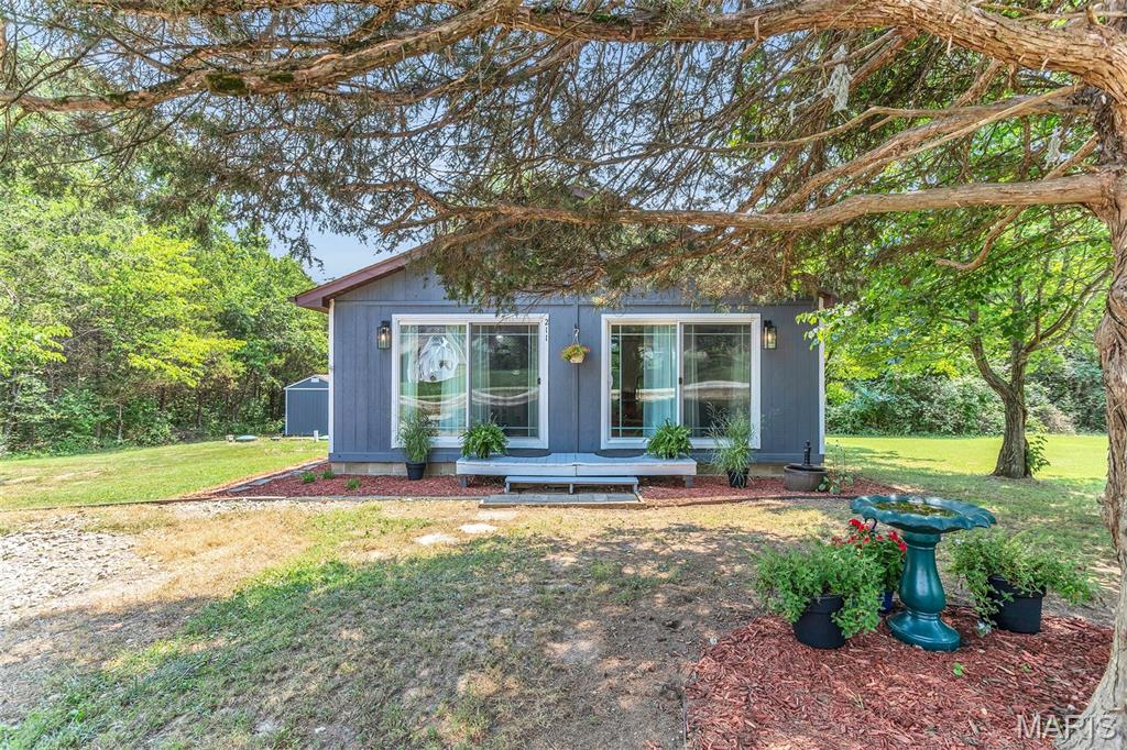Cute as can be on Blueberry! Welcome to your perfect lake retreat in the highly sought-after, gated Summer Set Lake community. Can summer get any better than weekends at the lake? Whether you're searching for a peaceful getaway or a place to enjoy lake life year-round, this adorable 2-bedroom home is ready to make every season feel like vacation season. Inside, gorgeous hardwood floors flow throughout the open-concept great room, where the family room, dining area, and kitchen come together to create an inviting space that's perfect for gathering. Down the hall, you'll find two nice sized bedrooms, a full bath, laundry area, and an additional storage room. Start your mornings with coffee on the back deck as you take in the tranquil water views surrounded by towering trees or unwind in the evening while enjoying the peaceful sounds of nature. A newer storage shed provides plenty of space for all your lake toys and outdoor gear. Situated on a mostly level double lot, this property offers room to spread out, entertain, garden, or even explore future expansion possibilities. Living in Summer Set means enjoying an incredible lifestyle with access to multiple private lakes for boating, fishing, kayaking, swimming, plus a sandy beach, campground, picnic areas, playgrounds, and endless opportunities to relax and make memories with family and friends. Conveniently located just minutes from shopping and dining in downtown De Soto and less than an hour from the entertainment, dining, and sporting events in St. Louis. Whether you're looking for a weekend escape, or a full-time residence, this affordable lake home that's been lovingly maintained, is a rare opportunity you won't want to miss. The seller made many great updates to this home over the last several years including new hardwood floors, new hot water heater, new shed with concrete pad, and a new septic system just to name a few. Come see why life is simply better at the lake-schedule your private showing today!