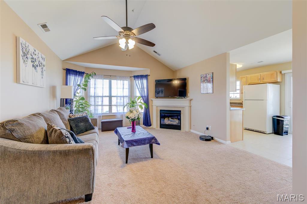 You will love this 1051 sqft 2-bedroom 2-bath condo with brand new carpeting throughout and excellent access to I-70, the St Peters Rec Plex, the YMCA, and lots of nearby parks, restaurants, and shopping.  As you step into the tiled entry foyer, you see a spacious great room featuring vaulted ceilings, a charming bay window, and a cozy gas fireplace.  The great room is open to the eat-in kitchen with a sliding door leading to your private covered balcony - perfect for sipping wine and watching the world go by.  This home offers a large primary bedroom, complete with a walk-in closet and an en-suite full bath. You'll also enjoy the conveniences of an in-unit laundry room off the entry foyer with a washer & dryer included.  Additional storage is available in a separate closet across the exterior hallway, and a dedicated carport space is located on the southern side of the building (#35). Experience maintenance-free living, as the HOA covers water, sewer, trash collection, snow removal and access to the POOL area and playground.  It is now vacant and move-in ready, so come see your new home!