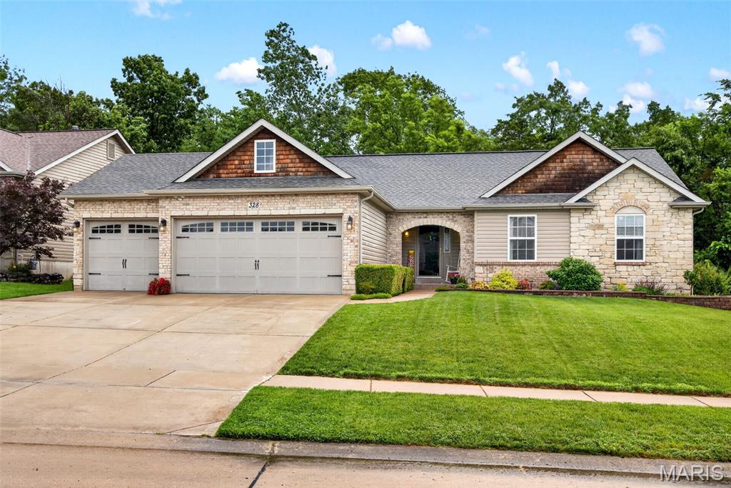 Welcome Home! Mrs Clean lives here! Single owner home has been well cared for and it shows! The curb appeal is loud and clear with a great exterior with shake siding, stone portico covered porch and beautiful landscaping! Step into the foyer and see  lovely wood plank floors that carry through the large great room framed with great windows for natural light and a wood burning fireplace. The large kitchen/breakfast combo offers plenty of cabinet storage, SS appliances, a pantry, solid surface counters and a great coffee bar. The sep dining room offers access to the deck that overlooks the private yard and patio backing to trees. The main level laundry leads to the oversized THREE car garage. A spacious master ensuite with full bath is a private sanctuary!  The two secondary bedrooms share the hall bath and linen storage. Downstairs to the entertainers delight! This walkout basement has room for great gatherings and space for the family to spread out! A Full bath, bar area, rec area, TV area and more. The current exercise room has a closet and could be converted to a 4th bedroom with the addition of one wall. Pride of ownership shows in this great ranch with over 3100 SQ ft of living space. Settled in the quiet subdivision of Newport Meadow in Wentzville- North Point schools, just minutes from Hwy 61 access. You have found the one you are looking for! Unpack your boxes- you are HOME!