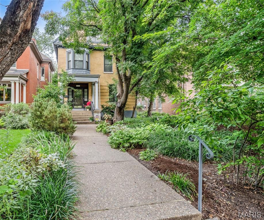 Welcome to 4421 Laclede Avenue, located in Laclede Place. This charming, semi-private block of Laclede Avenue is distinguished by its beautifully landscaped boulevard, mature trees, and timeless architectural character. This exceptional home is being offered for the first time in 45 years and has been lovingly maintained and thoughtfully updated throughout.
Step into the stunning foyer, where original millwork and a beautiful fireplace create an unforgettable first impression. Separated by pocket doors, the gracious living room features its own fireplace, while the formal dining room offers yet another fireplace.
The chef's kitchen is designed for both everyday living and entertaining, featuring custom cabinetry, stainless steel appliances, and an oversized center island. Just beyond, the expansive great room is filled with natural light from an abundance of windows, creating a bright and inviting gathering space.
The second floor is anchored by the luxurious primary suite, complete with a fireplace and a spa-inspired bath featuring dual vanities, heated floors and a separate walk-in shower. The second bedroom has a wall of custom built-in bookcases and its own fireplace; a third bedroom and an additional full bath complete the second floor.
The third floor offers even more flexibility with two additional bedrooms and another full bath, providing ample space for family, guests, or a home office. The finished lower level, complete with egress windows and abundant natural light, offers flexible living space perfect for a home office, playroom, or recreation area and includes a convenient half bath, additional storage space and cedar closet. Find your own private oasis in the backyard, thoughtfully designed for both relaxation and entertaining. Enjoy a charming screened-in room, a spacious deck perfect for grilling and outdoor dining, and a covered hot tub for year-round enjoyment. The beautifully curated grounds feature an impressive variety of plantings—from fresh vegetables and lush landscaping to your very own banana plants—creating a truly unique outdoor retreat. A rare blend of historic elegance and peaceful surroundings, this exceptional location places you just moments from the vibrant shops, restaurants, and cultural attractions of the Central West End while maintaining a quiet, neighborhood feel. Close to Barnes Jewish, WashU Med School, The Cortex and Saint Louis University.