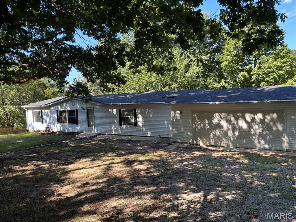 Welcome home to your own private piece of the country! This inviting 3-bedroom, 2-bath manufactured home sits on over 5 wooded acres, offering a peaceful and secluded setting surrounded by nature.

Inside, you’ll find new carpeting in two of the bedrooms and new flooring throughout the kitchen area. The home also features an added breakfast room behind the garage, providing extra space for morning coffee, family meals, or entertaining. Just off the garage is a wonderful three-season room—a perfect spot to relax and enjoy the beautiful surroundings.

The oversized 32' x 32' garage offers plenty of room for vehicles, hobbies, storage, and more. The home has a full foundation, private well, and septic system.

Tucked away on over five acres of mostly  wooded ground, this property offers privacy, space, and the opportunity to enjoy country living while still being close to the conveniences you need. Come take a look—you may just find the peaceful place you’ve been waiting for a new family to call it home!