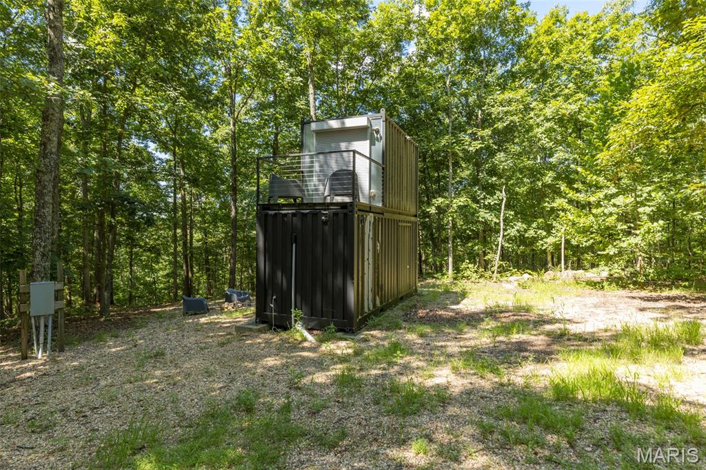Motivated Sellers!!! Check out this amazing opportunity to have a 21 acre M/L tract of land with a private "bug out shelter" or container home that would be perfect for a get away spot for regular camping or a small primary residence. This unique property is built out of shipping containers for a perfect little to no maintenance shelter that is secure and durable, featuring a kitchen full bathroom and an upstairs room with a balcony with a drilled well and septic, heating and cooling system are high efficiency mini splits. Along with the large tract of land there is community exclusive access to black river for those hot summers to relax on the rive not far from K bridge. Check out this listing while you have a chance.