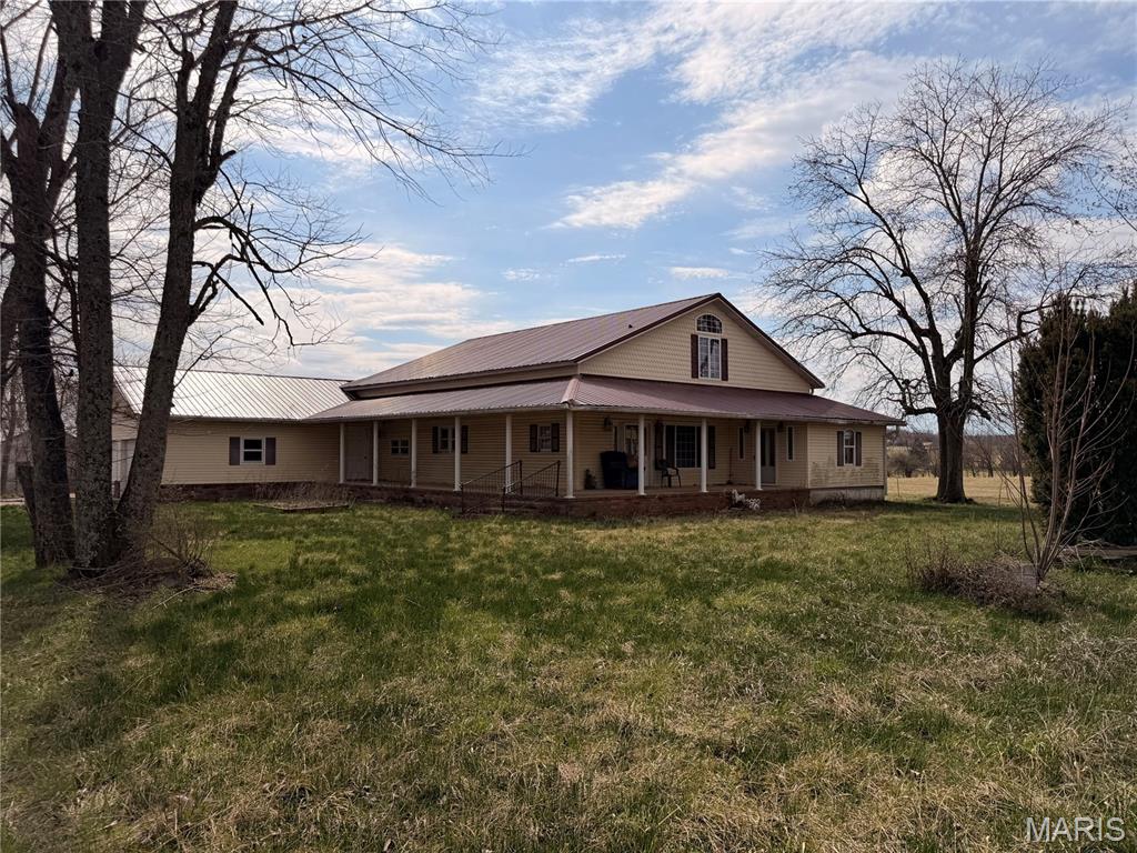 Opportunity awaits on 2.45 scenic acres! This spacious farmhouse offers over 3,200 sq. ft. of living space with 3 bedrooms, 4 bathrooms, and endless potential for investors, rehabbers, flippers, or buyers looking to build instant sweat equity. Enjoy the charm of country living with expansive covered front and side porches, a rear deck, and peaceful views of the surrounding farmland. The oversized attached garage provides ample storage and workspace, while two additional outbuildings offer plenty of room for vehicles, equipment, lawn machinery, hobbies, or future projects. The upper-level bedroom features vaulted ceilings, a private bath, and generous walk-in closet space. With solid square footage, multiple outbuildings, and a desirable rural setting, this property presents a rare opportunity to create something special. Property is being sold strictly AS-IS; seller to make no repairs or inspections.