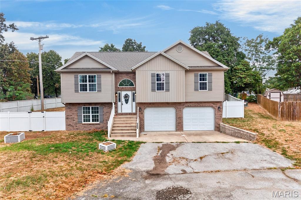 Located at the end of a quiet cul-de-sac in the Taylor Hills subdivision, this split-foyer home welcomes you in up to an open living room, with vaulted ceiling and solid surface flooring, over to the eat-in kitchen complete with breakfast bar, stainless steel appliances, double bowl stainless sink overlooking the fenced yard and even a doggy door to the deck! Down the hall, the primary bedroom includes a massive walk-in closet, barn door to primary bath that includes double bowl vanity, jetted tub and tiled shower. Down the hall, find two additional bedrooms and one full bath. Head downstairs to a family room, with access to the backyard.  The fourth bedroom includes en suite with spacious shower and tons of closet space! Laundry room is located on the lower level. Garage includes two car garage, plus extra hobby space and separate utility room. Garage includes 220v outlet, perfect for charging your e-car!