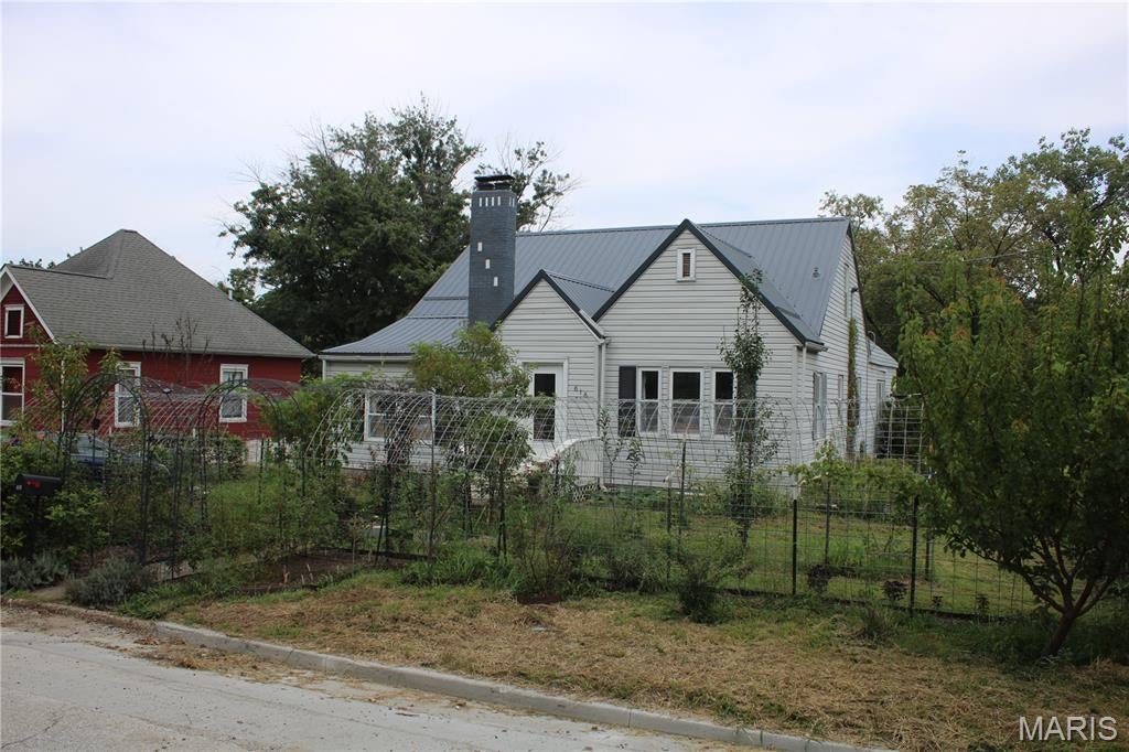 Four bedroom, two bathroom, story and a half home on a full unfinished basement with a one car detached garage located in Paris, MO. Home features a newer roof, newer HVAC, newer hot water heater, and a full scale solar panel system with a battery backup making for some cheap utility bills. Outside of the home there are numerous fruit trees, plants, and vegetables planted. The property consists of two city lots, and a nice area down below the home for a sitting area or fire pit area for entertaining guests. The one car garage is spacious and also comes with a full walkout basement under the garage that could be turned into a family room, or a guest room, or game room. The home does need a few repairs still. The back deck needs to be fully replaced and the fireplace will need a new flu liner installed before use. Even with a few things the home needs, the home itself offers upside potential in ample space, room for entertaining guests, and room to grow by finishing the garage basement!